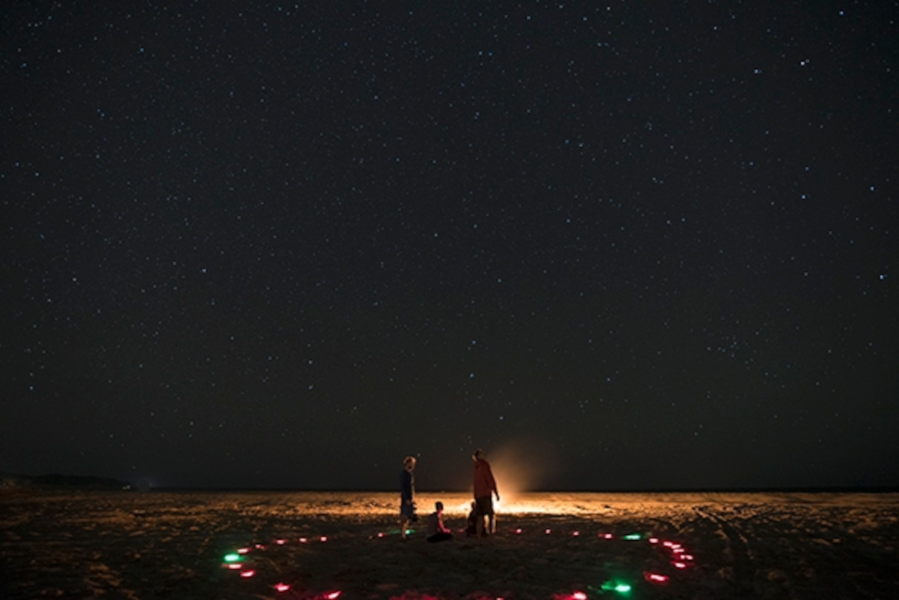 Austin Kino teaches the art of celestial navigation from the side of the bonfire; Photograph by Max Lowe