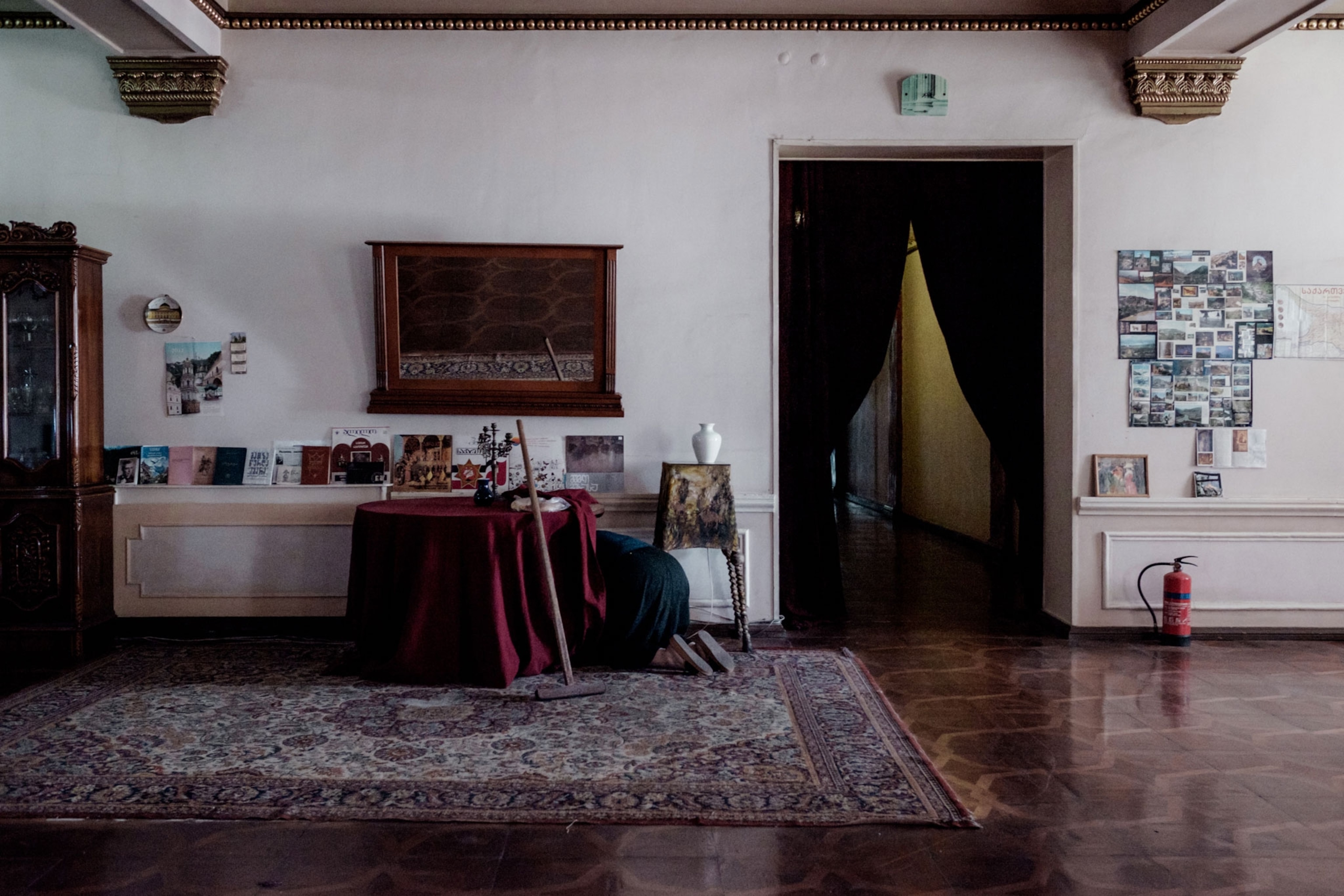 Nana, 58, reaches under a table in the reception hall to clean