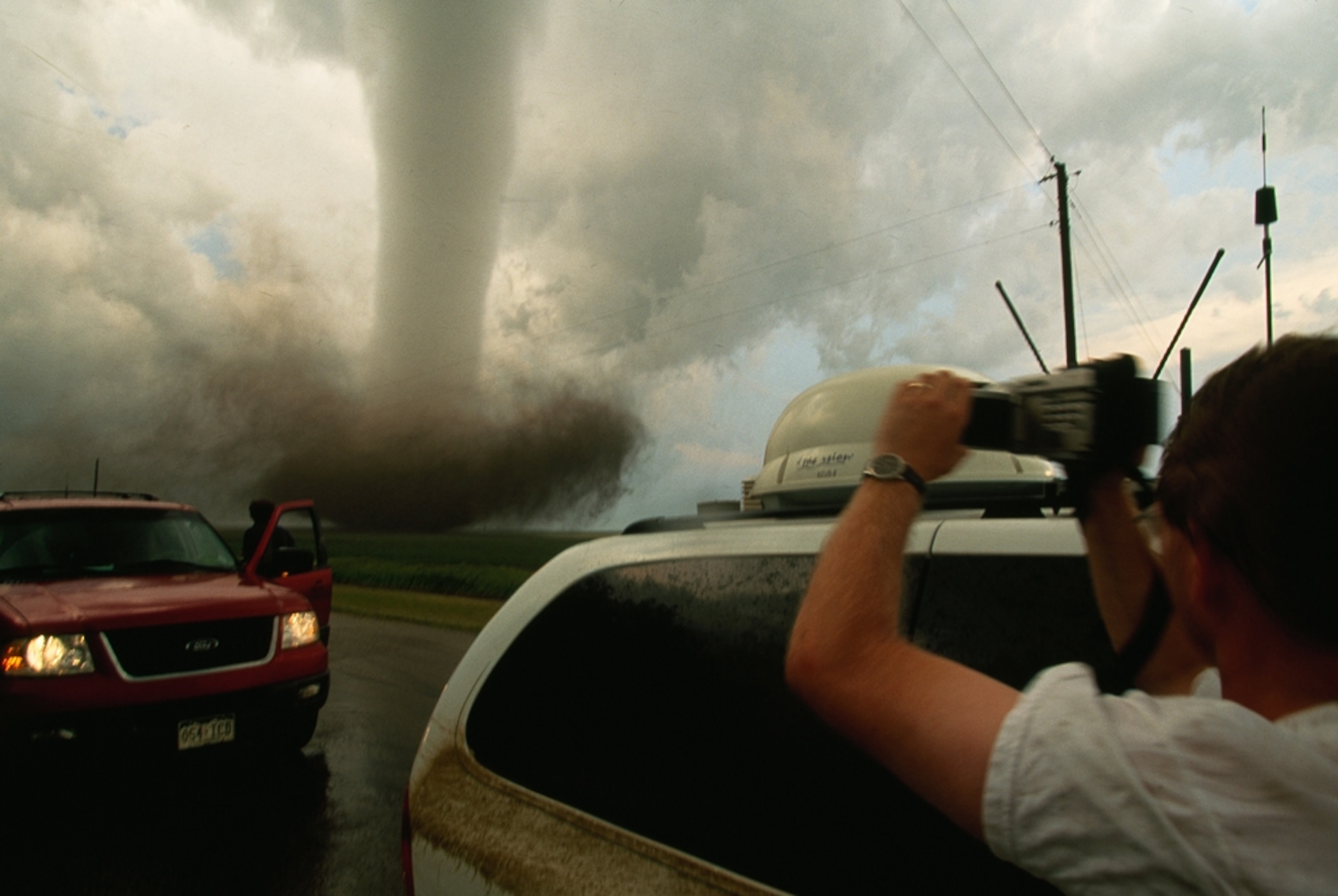 Storm chasers film a tornado.