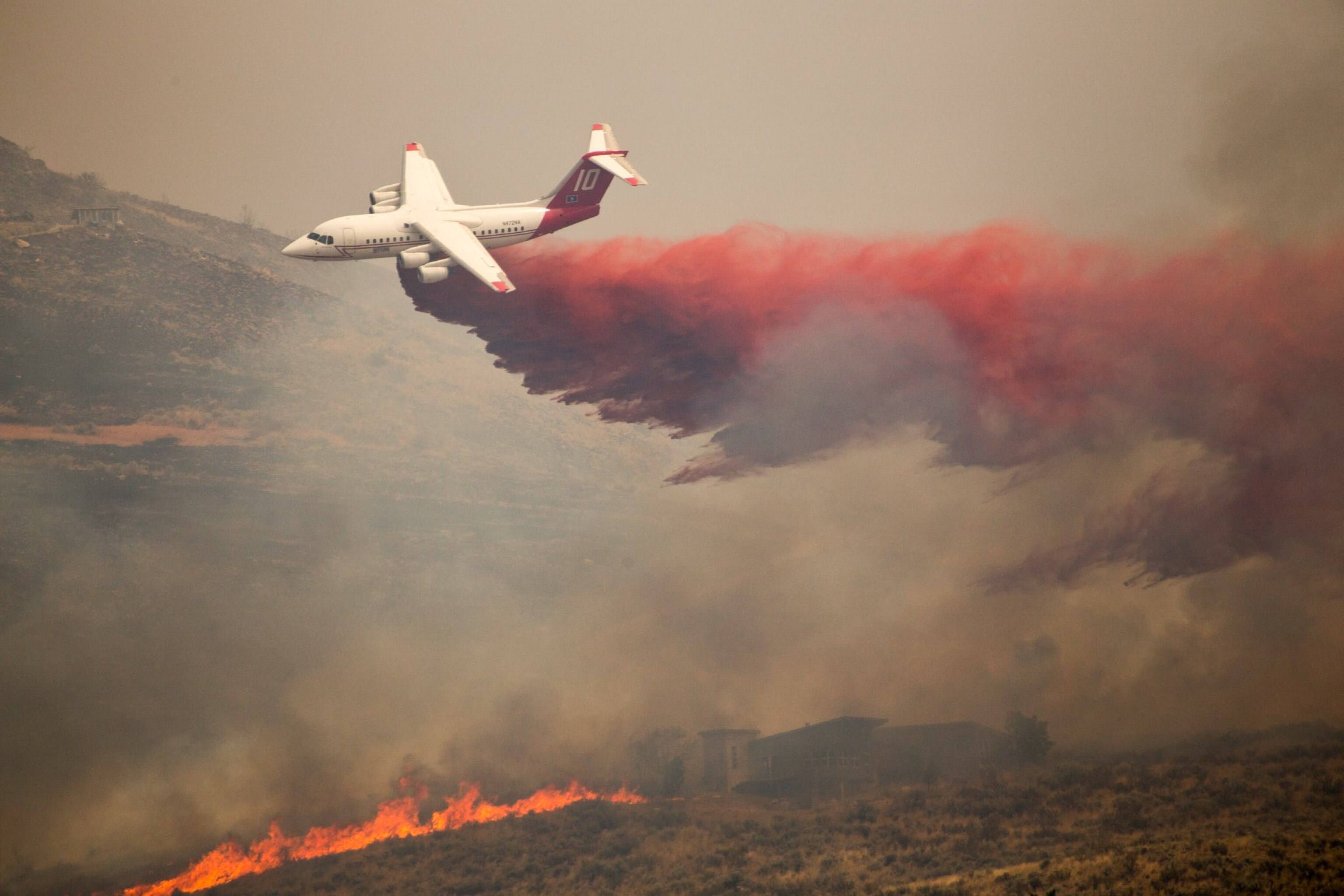 airtanker dropping retardant over a home near Twisp, WA.