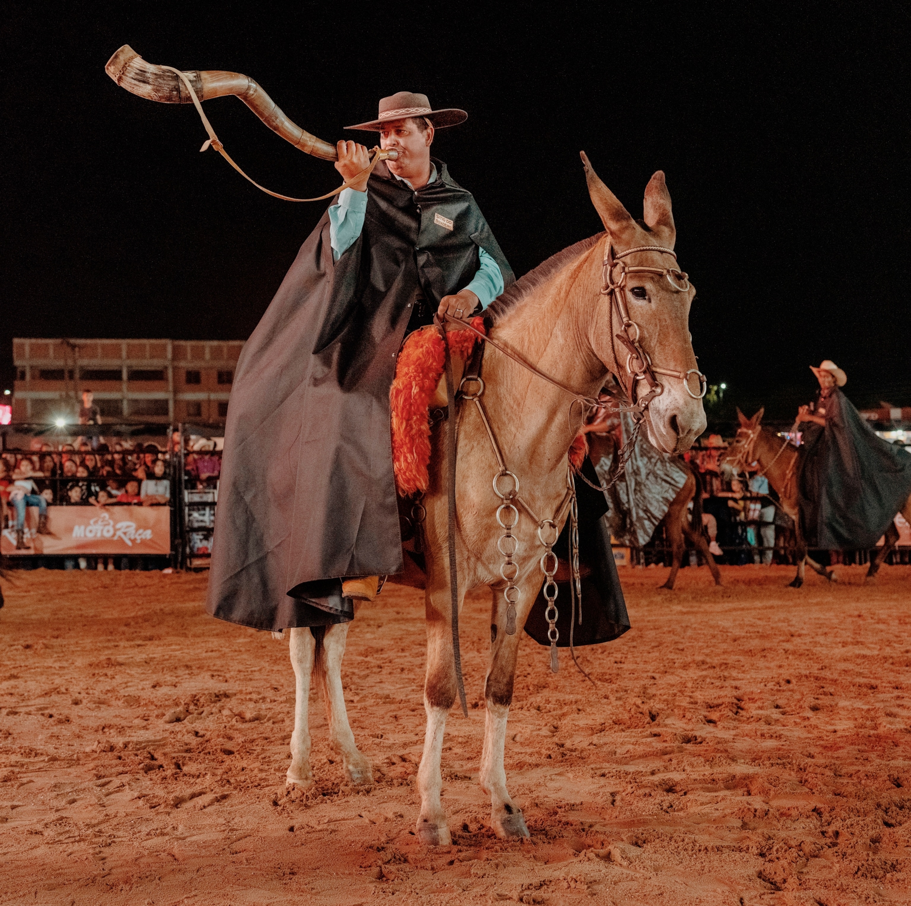 Here a man blows a traditional berrante—made from multiple cattle horns—as part of the rodeo’s kickoff.