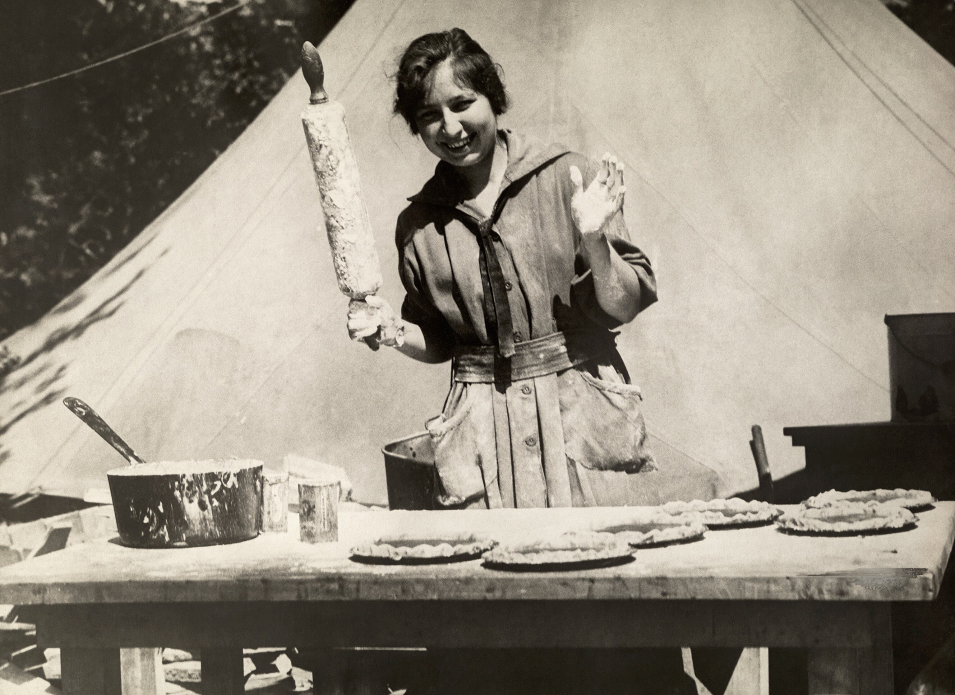 a woman holding a rolling pin