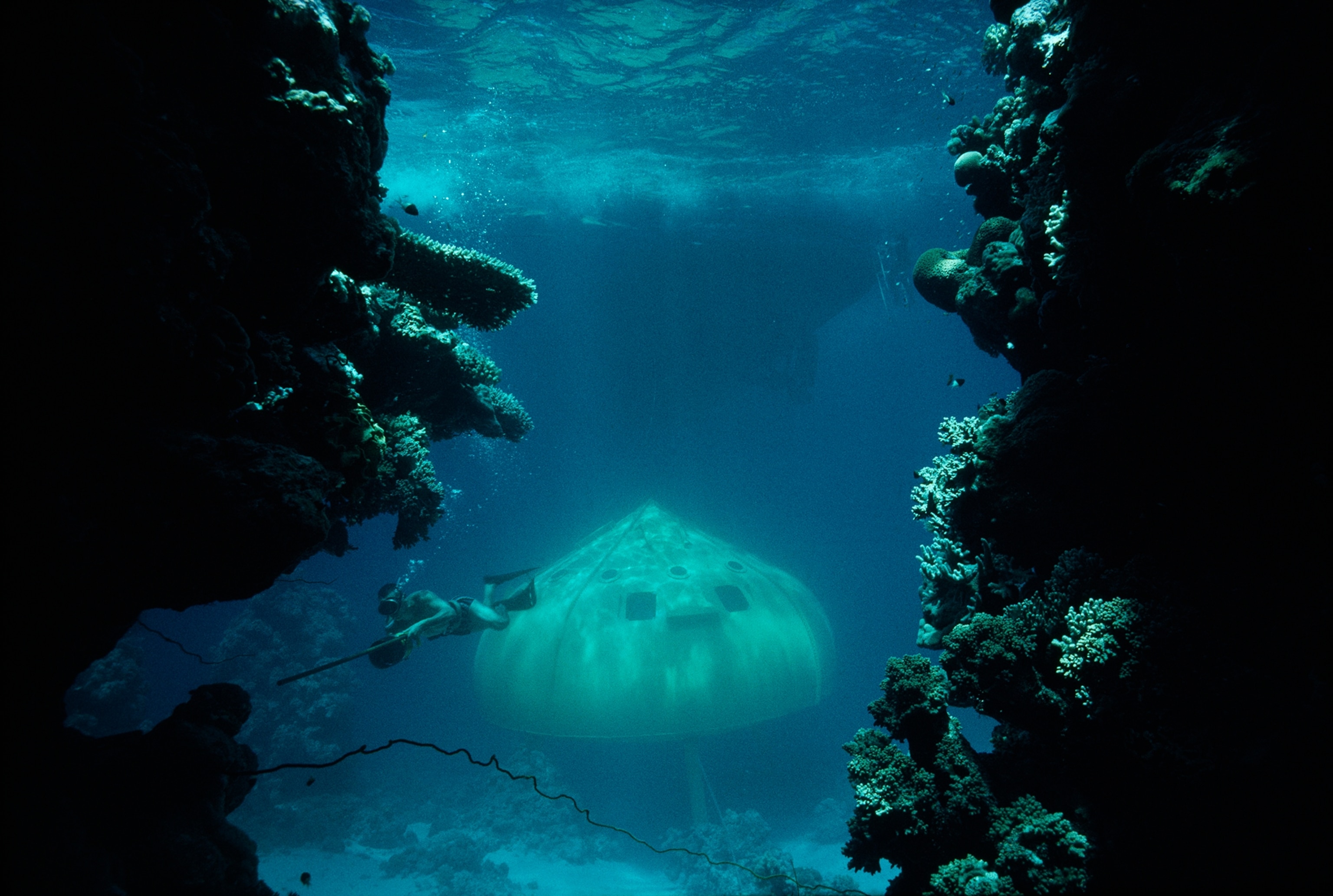 In 1963 a cameraman skirts Red Sea reefs near a dome housing Jacques-Yves Cousteau's diving saucer.