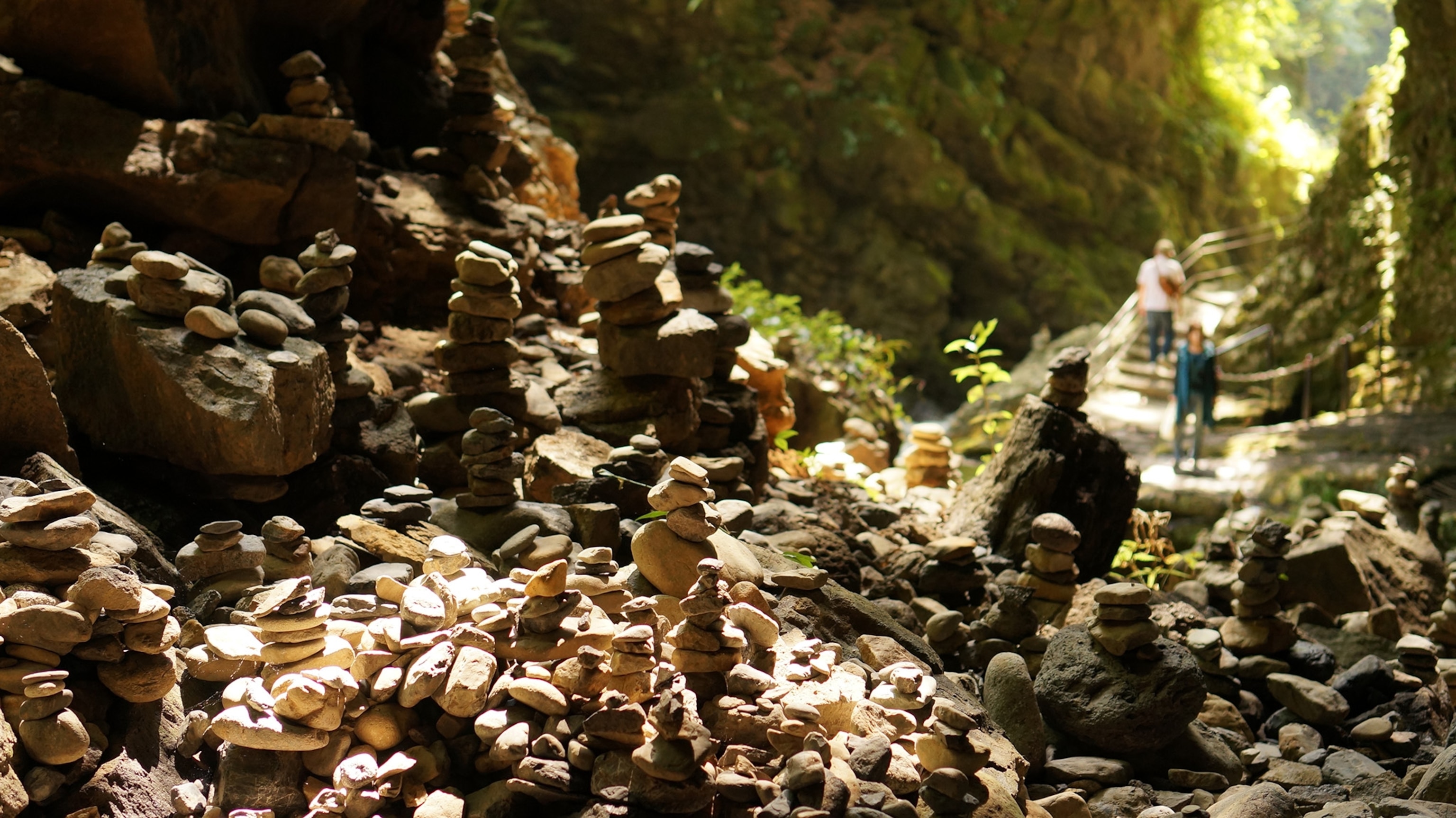 tan rocks stacked in a forest cave