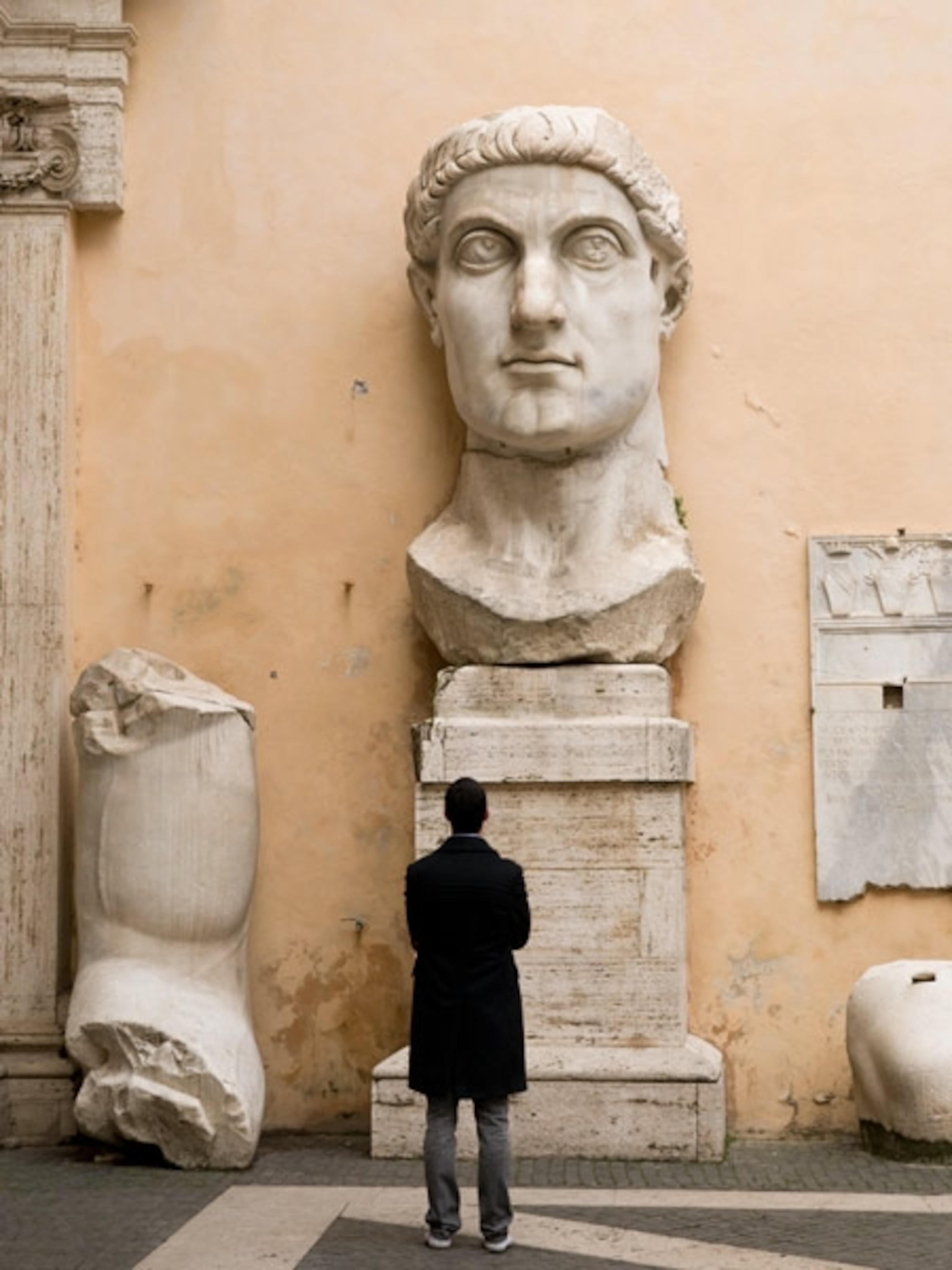 A tourist viewing a statue of Constantine