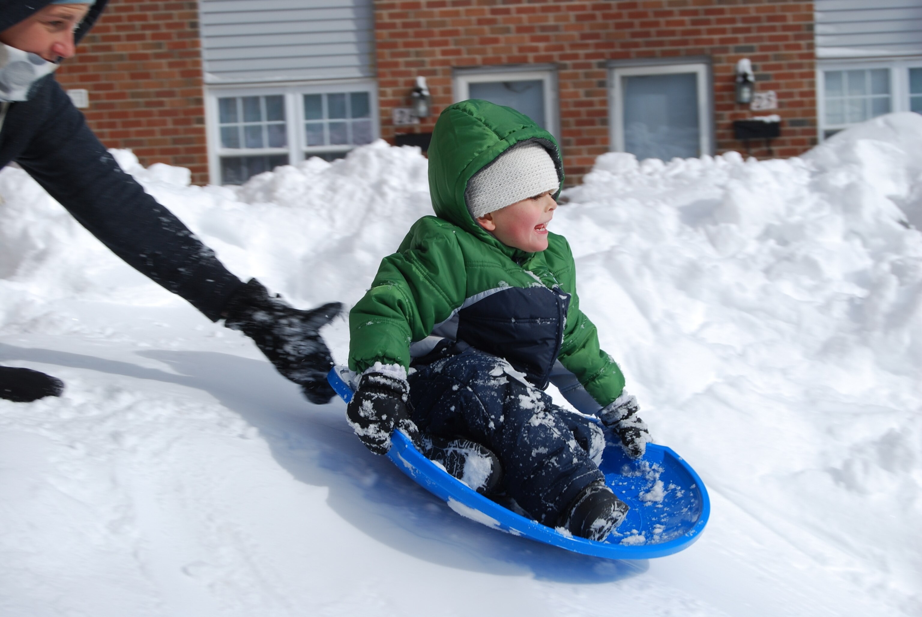 a boy on a sled in Connecticut during Nemo blizzard