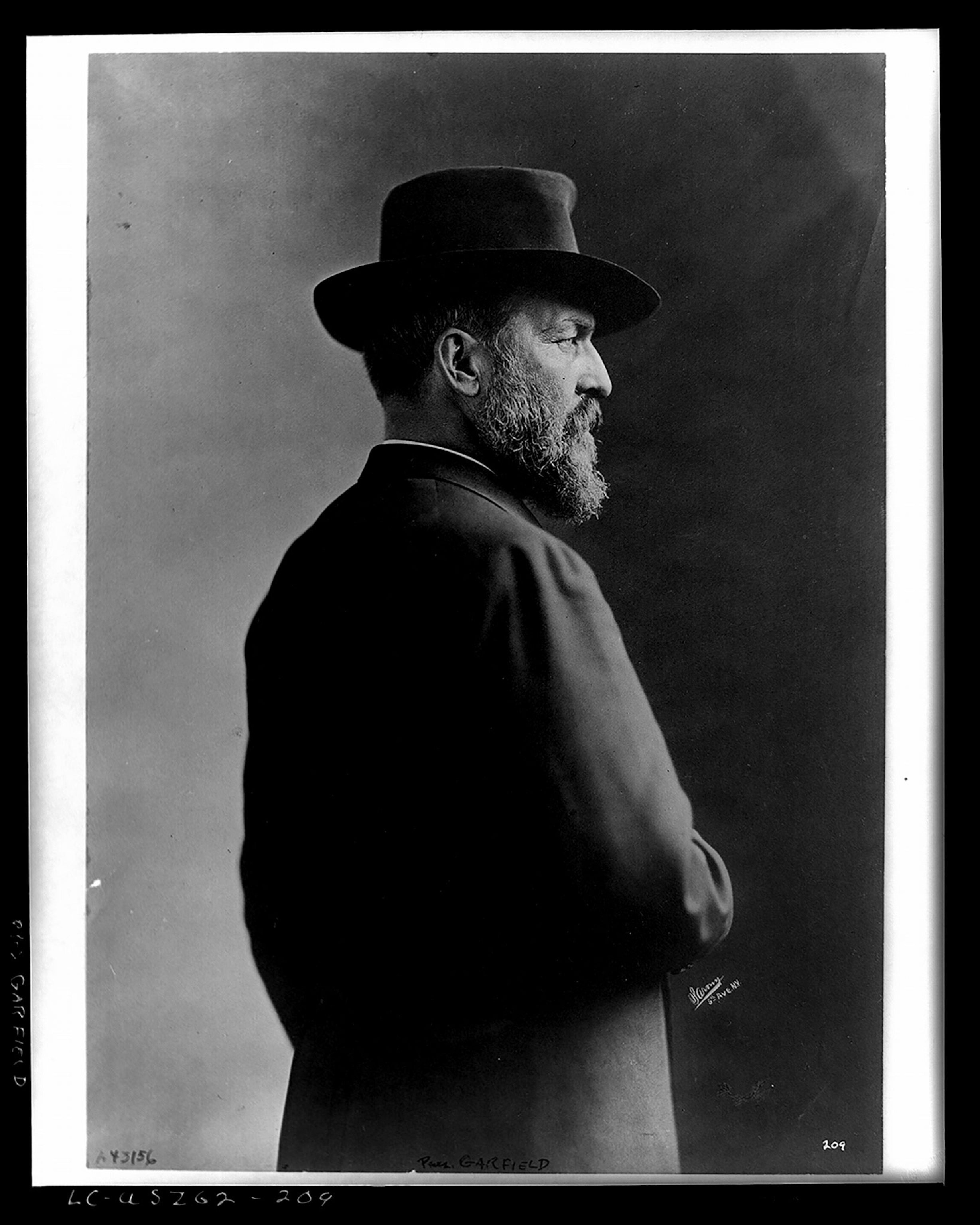 A man with a hat photographed in a room.
