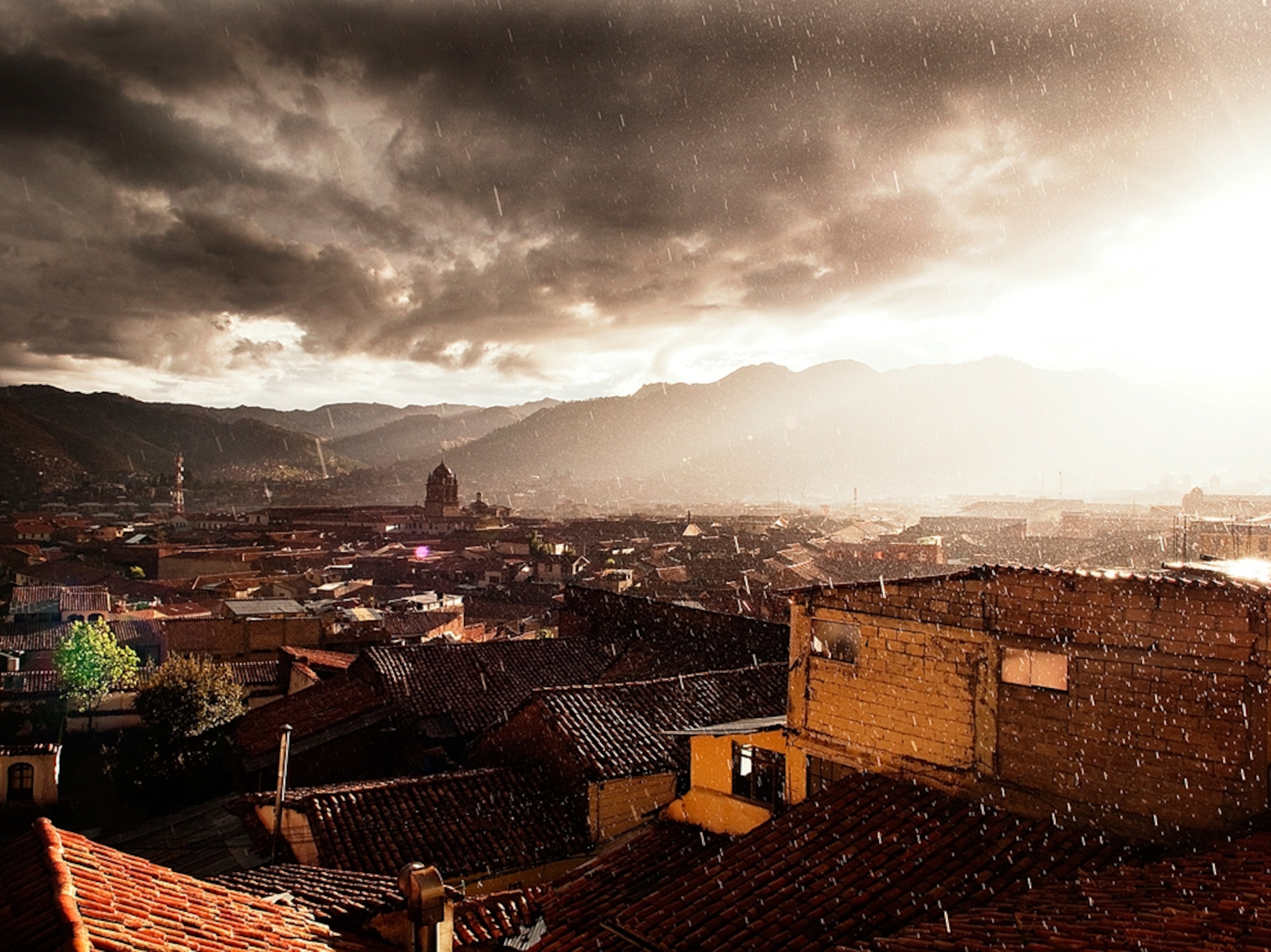 sunlight streaking through rain, Cusco, Peru