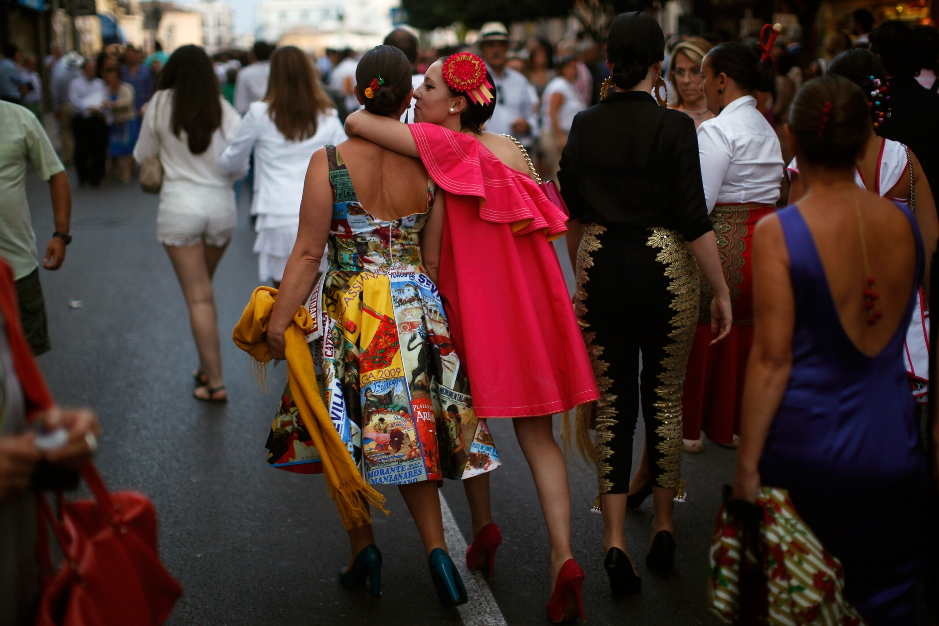 Pictures We Love - Picture of two women in bullfighter-theme clothing walking away from a bullring in Ronda, Spain