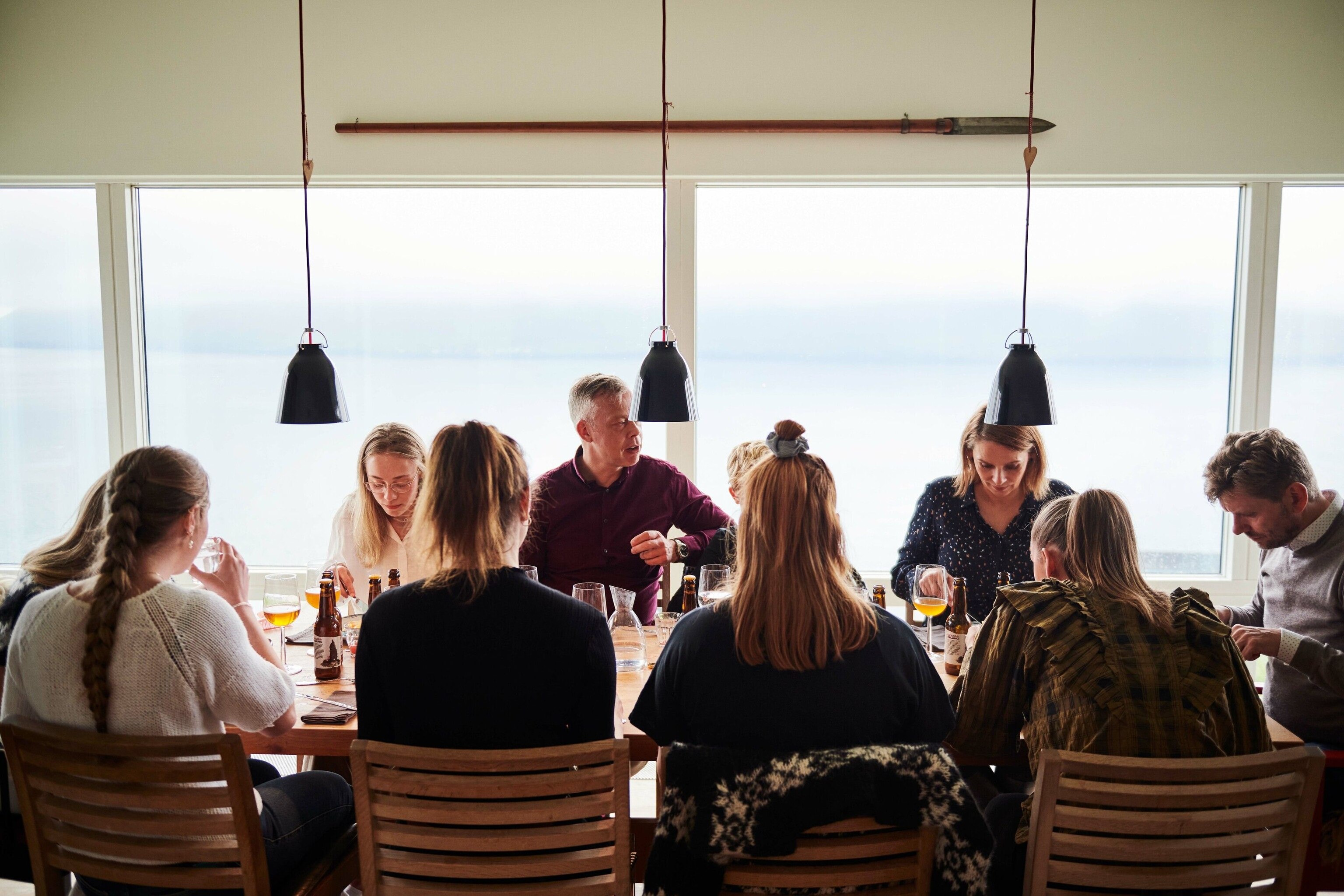 The Rubeksens’ guests enjoy their meal with glasses of local beer.