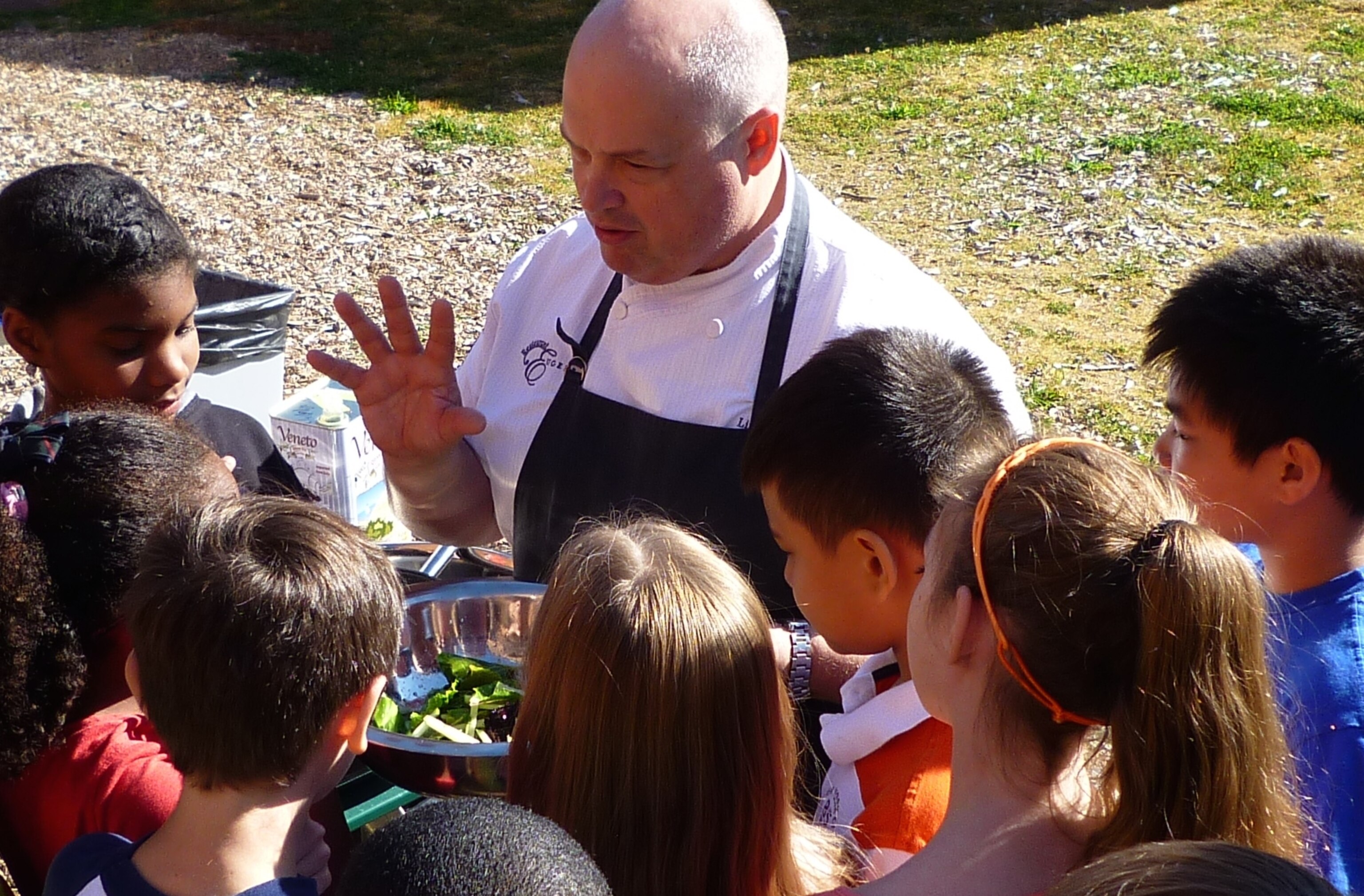 a chef teaching kinds about food.