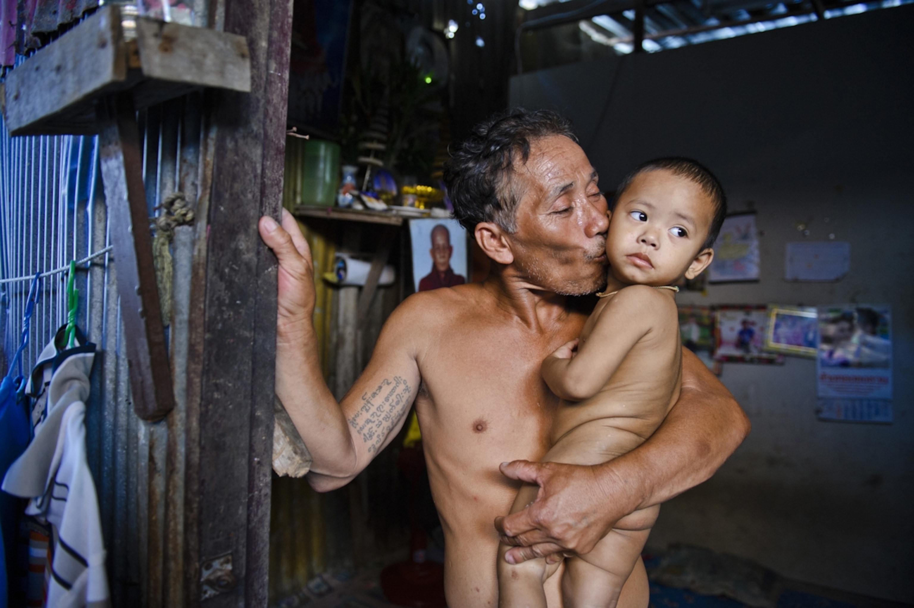 Many of the men spend a day, a week or up to a month out at sea on precarious fishing boats, earning about $200 a month, while the women work at the port or at home scaling and sorting fish. A man kisses his grandson goodbye as he’s about to leave on a ship for a few weeks.