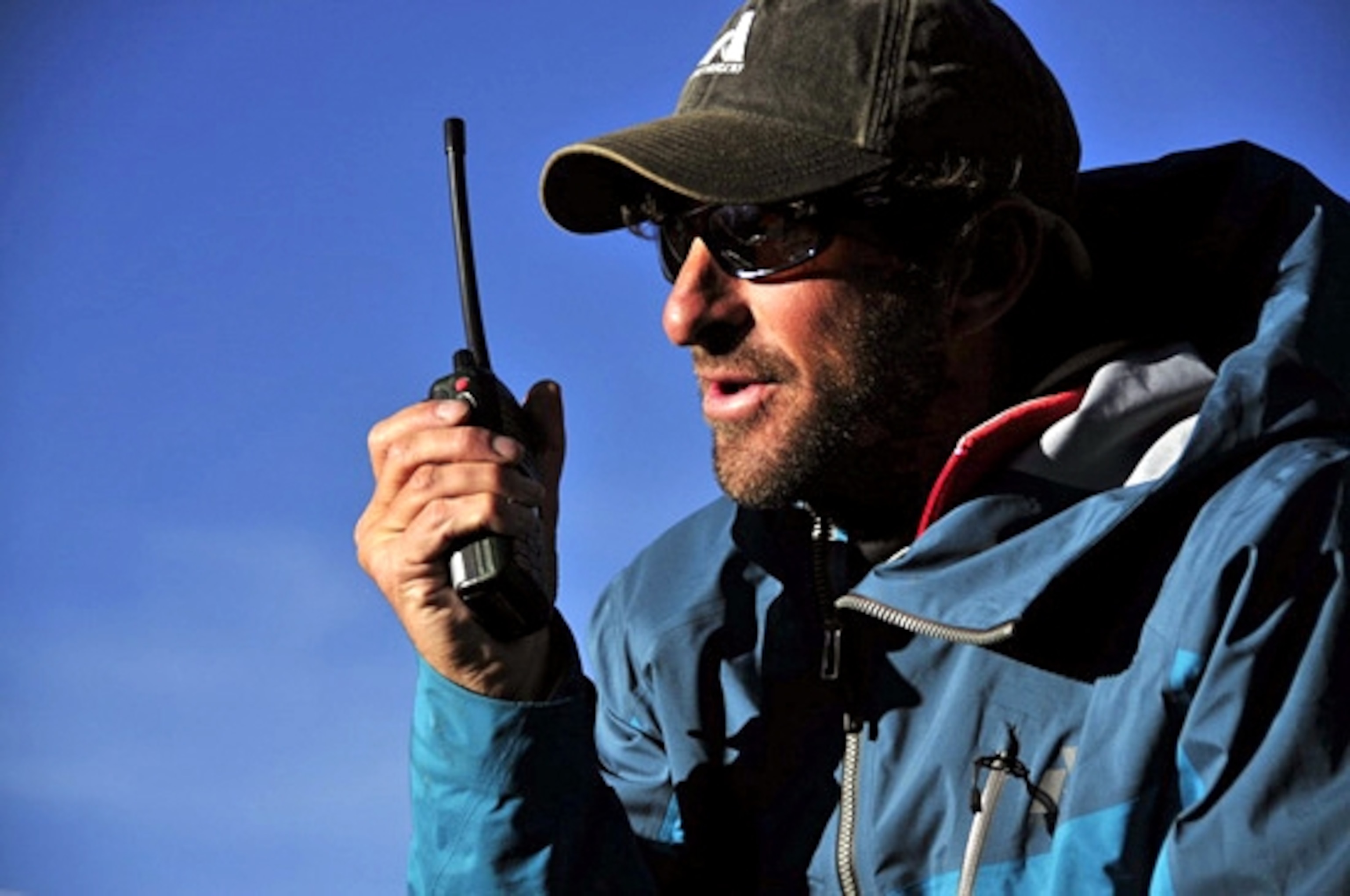 Dave Hahn speaks with team members on a radio on Everest