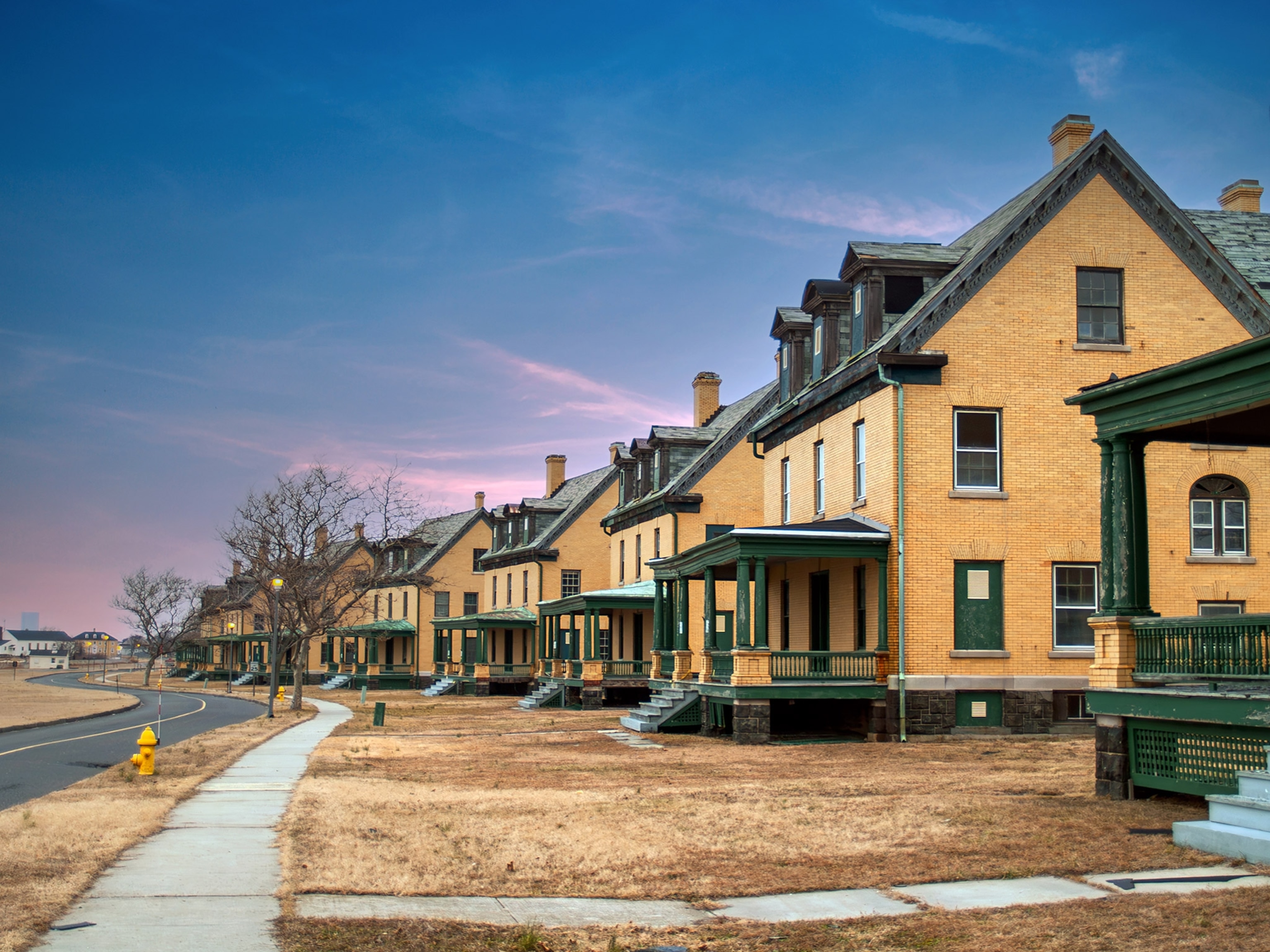 A row of identical houses along a road