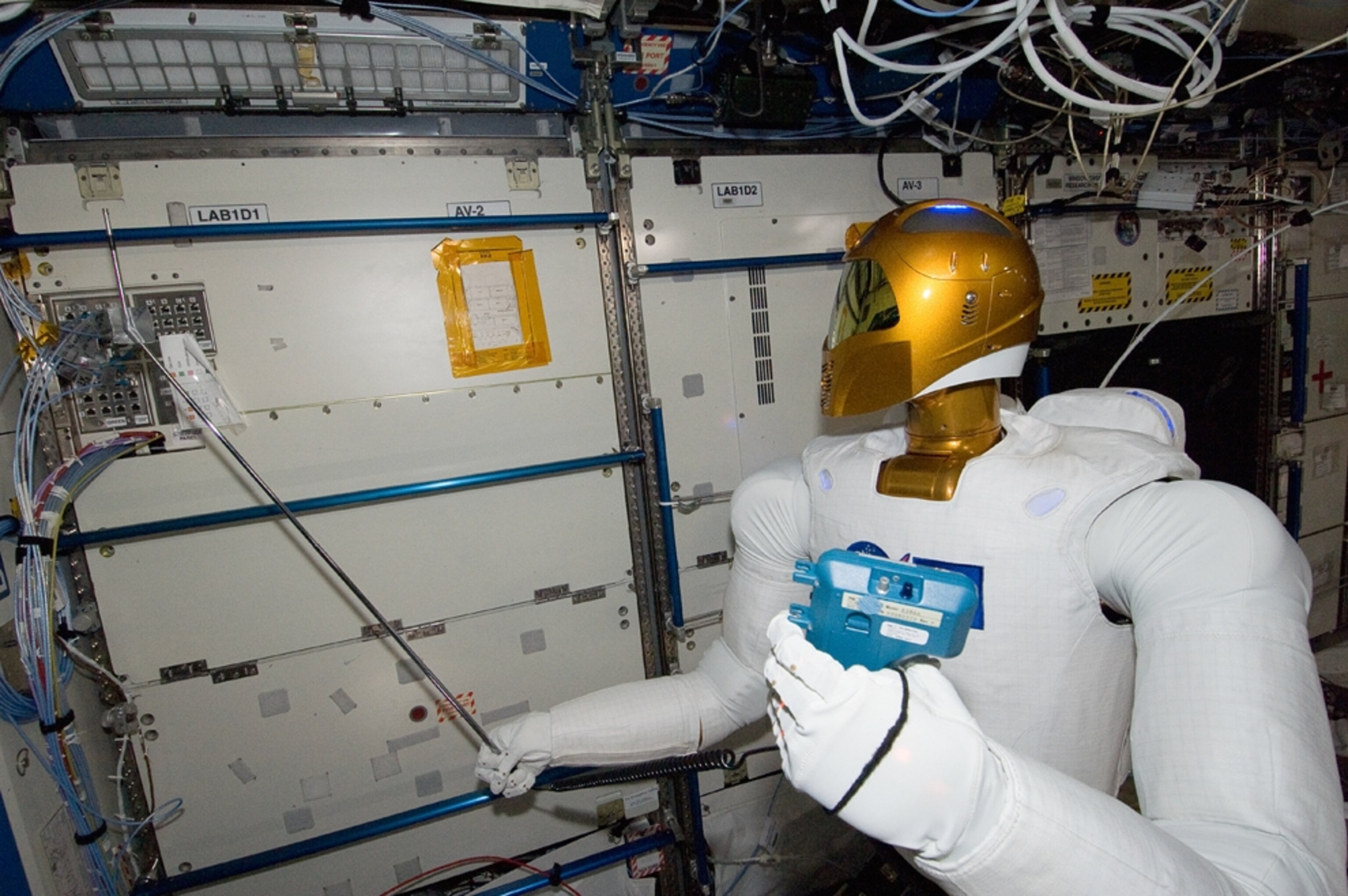 Robonaut picture: robot holding an instrument on the space station
