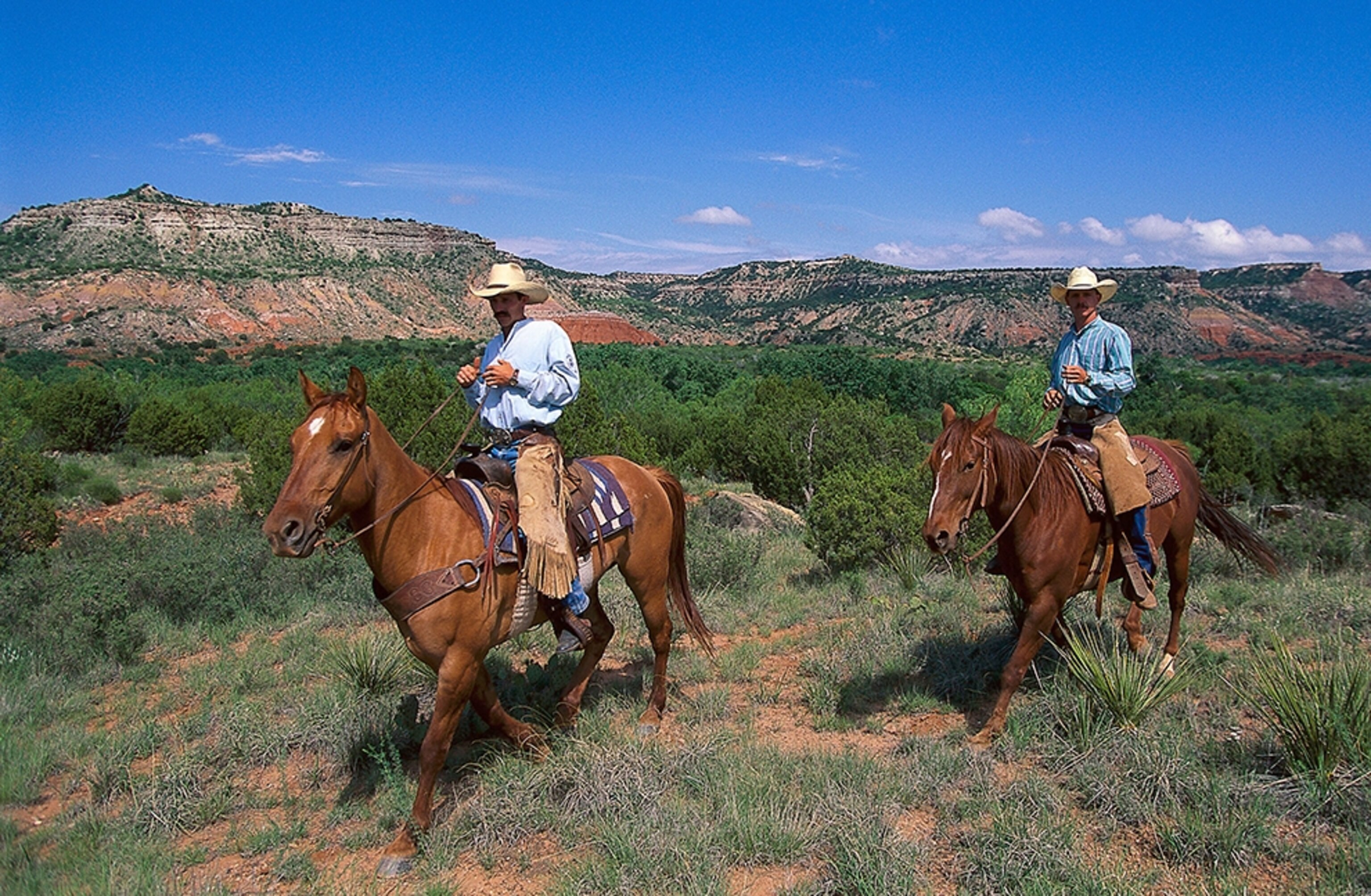 cowboys on horses in Palo Duro Canyon State Park, Texas