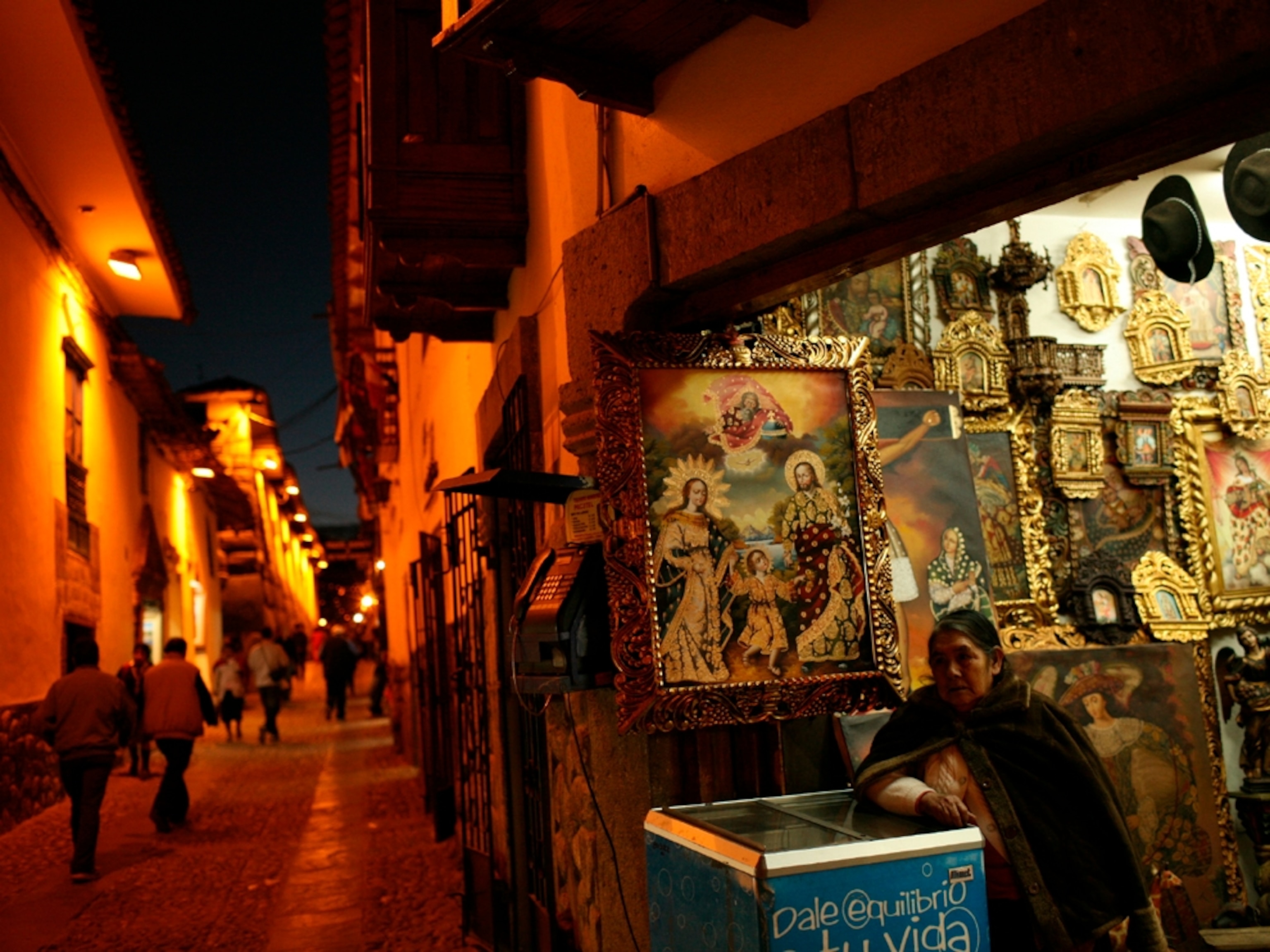 Photograph: A shop owner on a narrow street, Cusco, Peru