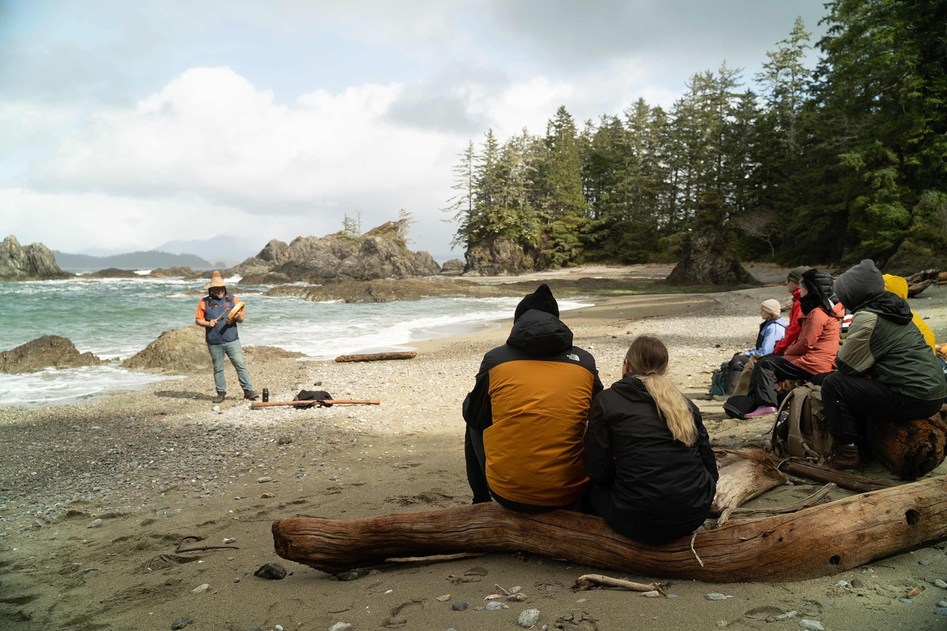 Festival visitors gather around for a the Huu-ay-aht First Nation Community's village tours
