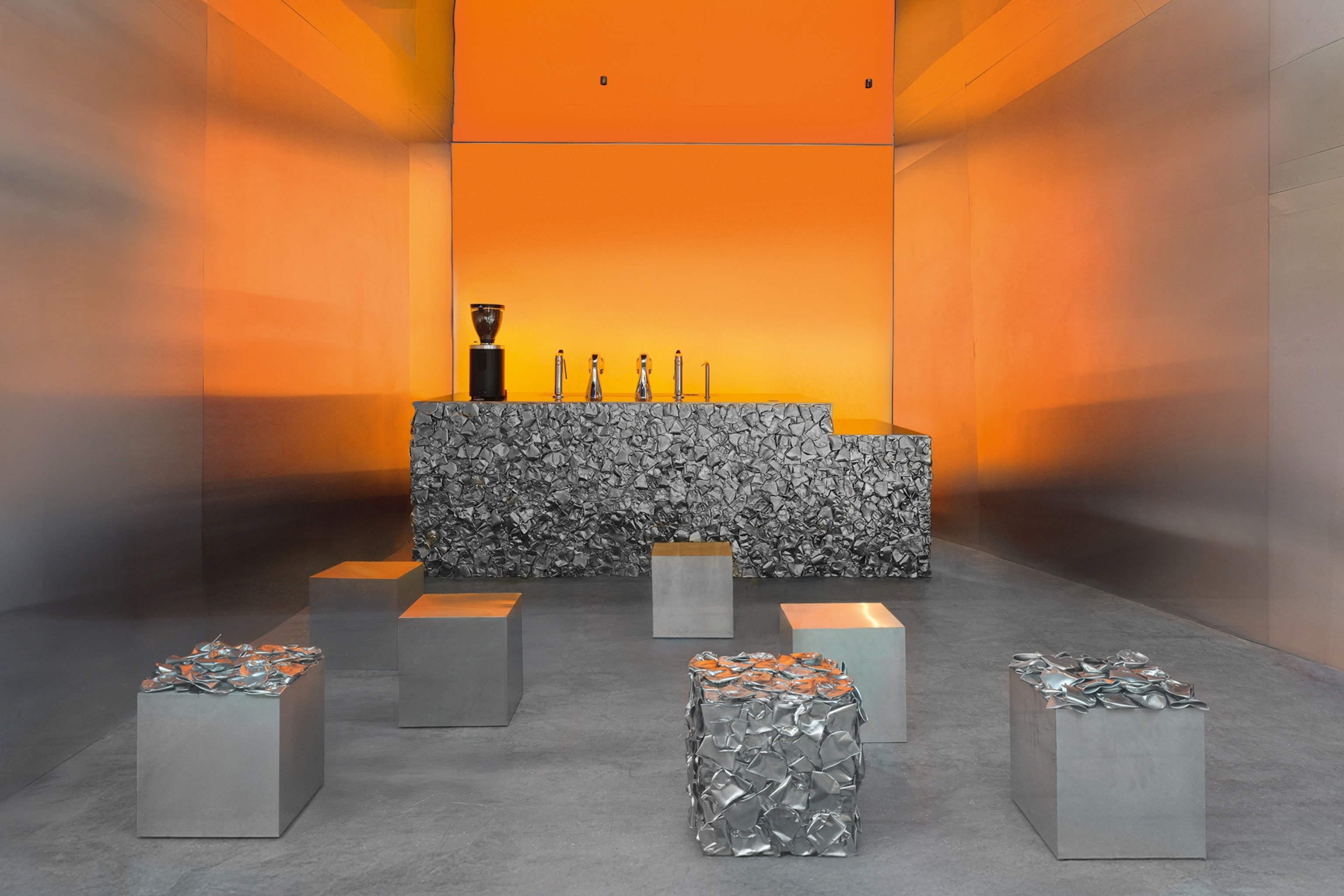 The interiors of a modernist cafe with plinths and colourful light.