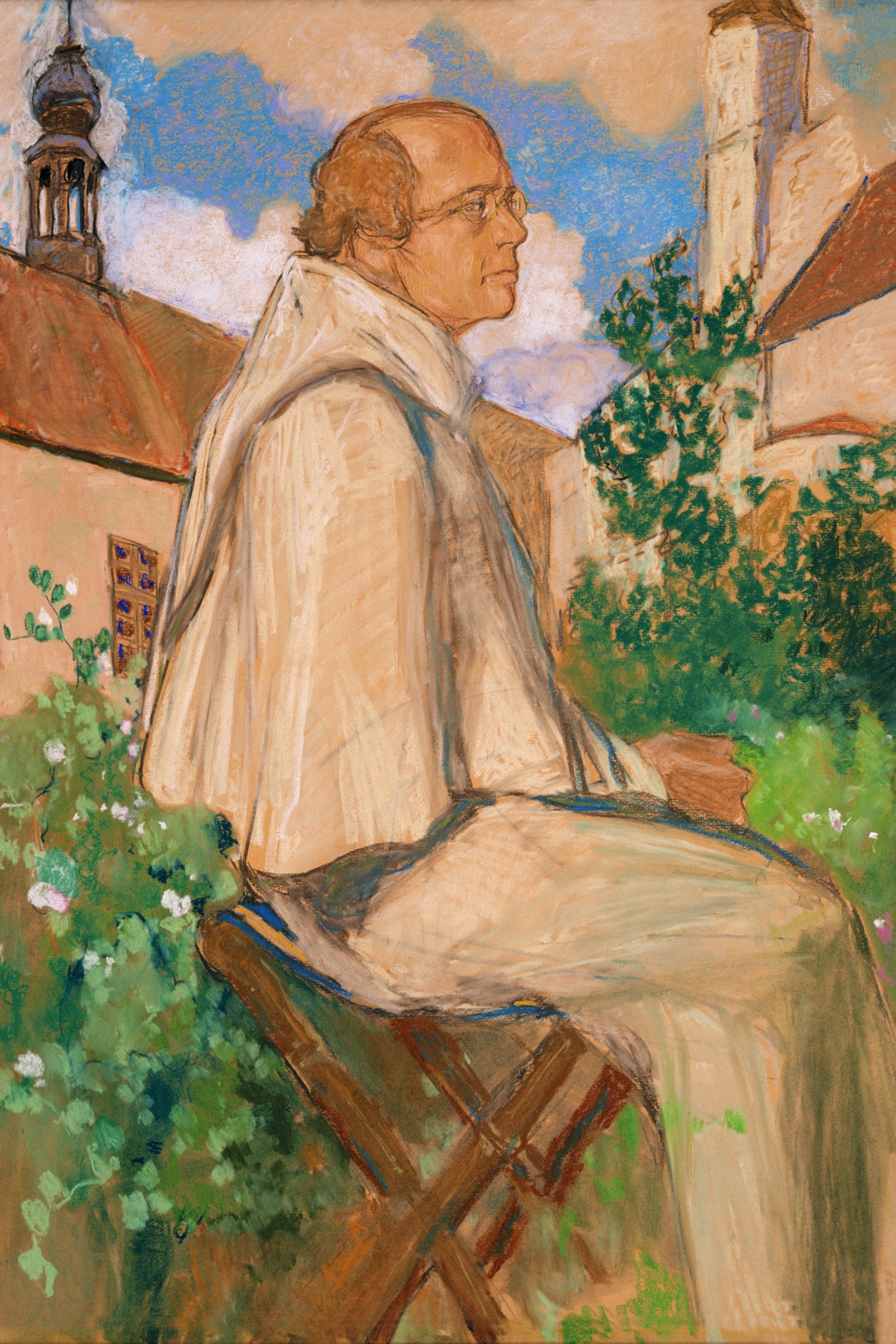 A person in white robes sits on a wooden bench in a garden with green foliage. A church tower and building are visible under a partly cloudy sky.