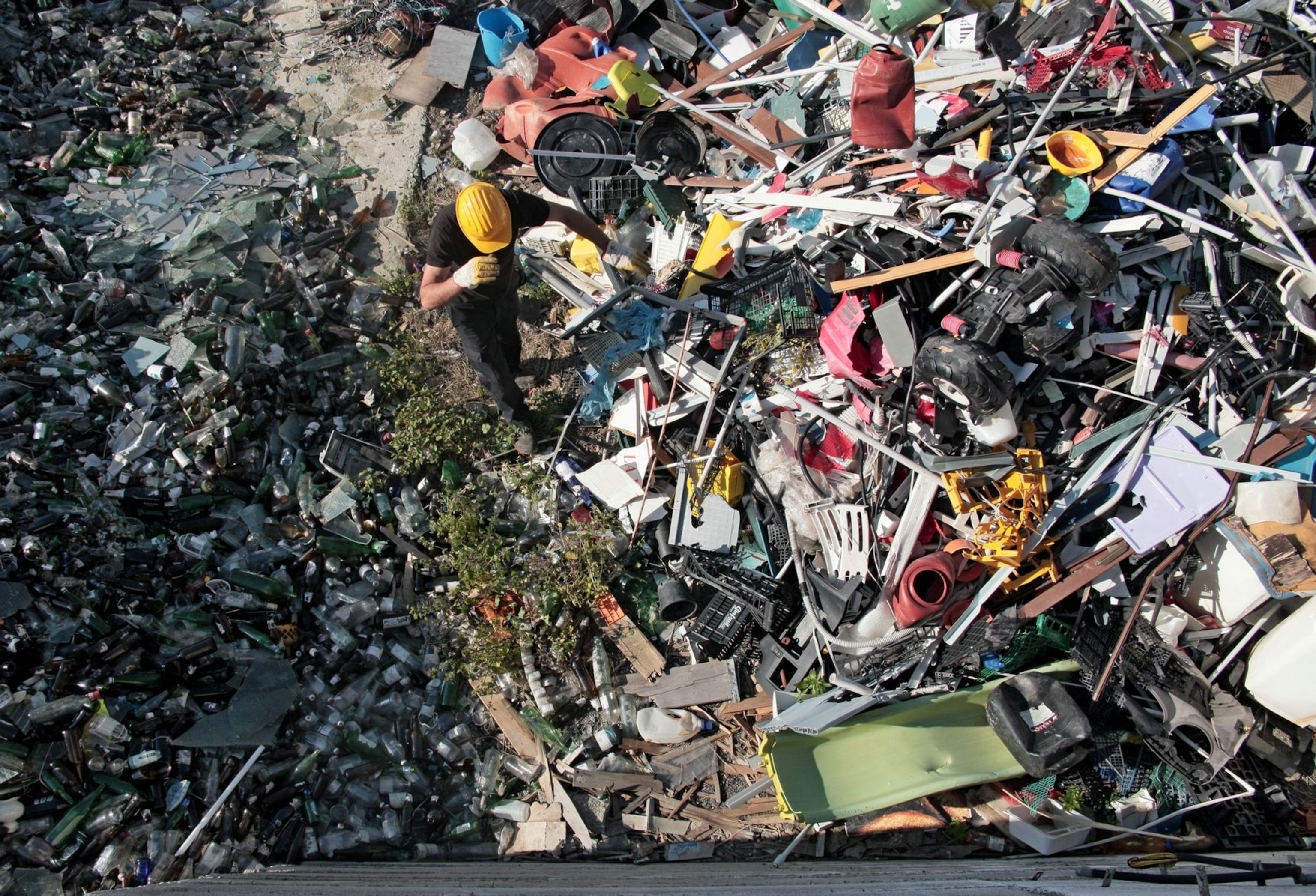 A man walks past sorted trash