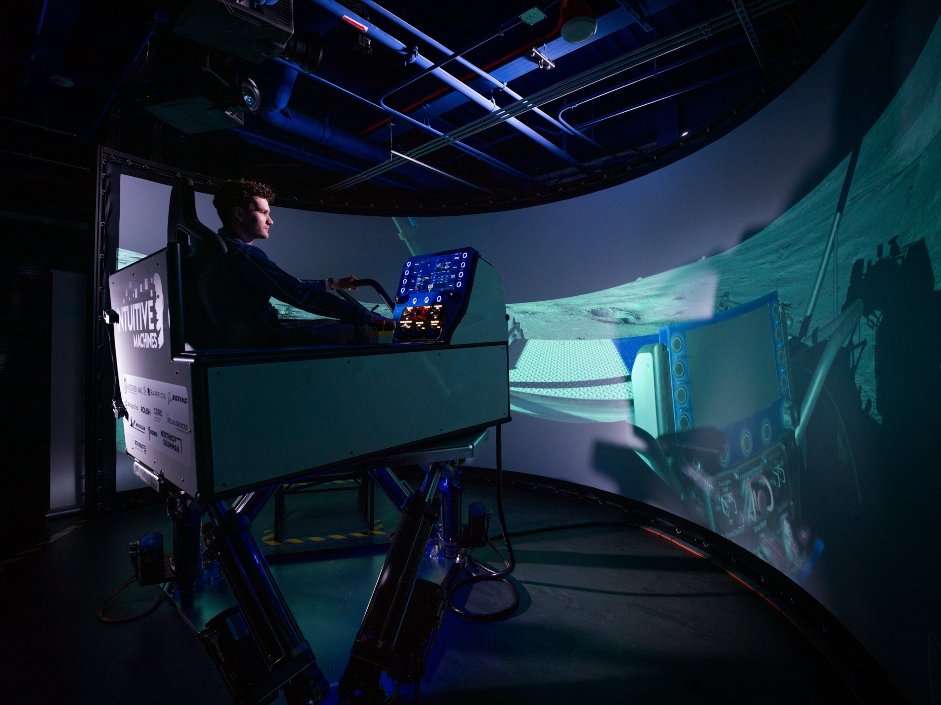 man sitting in front of large screen