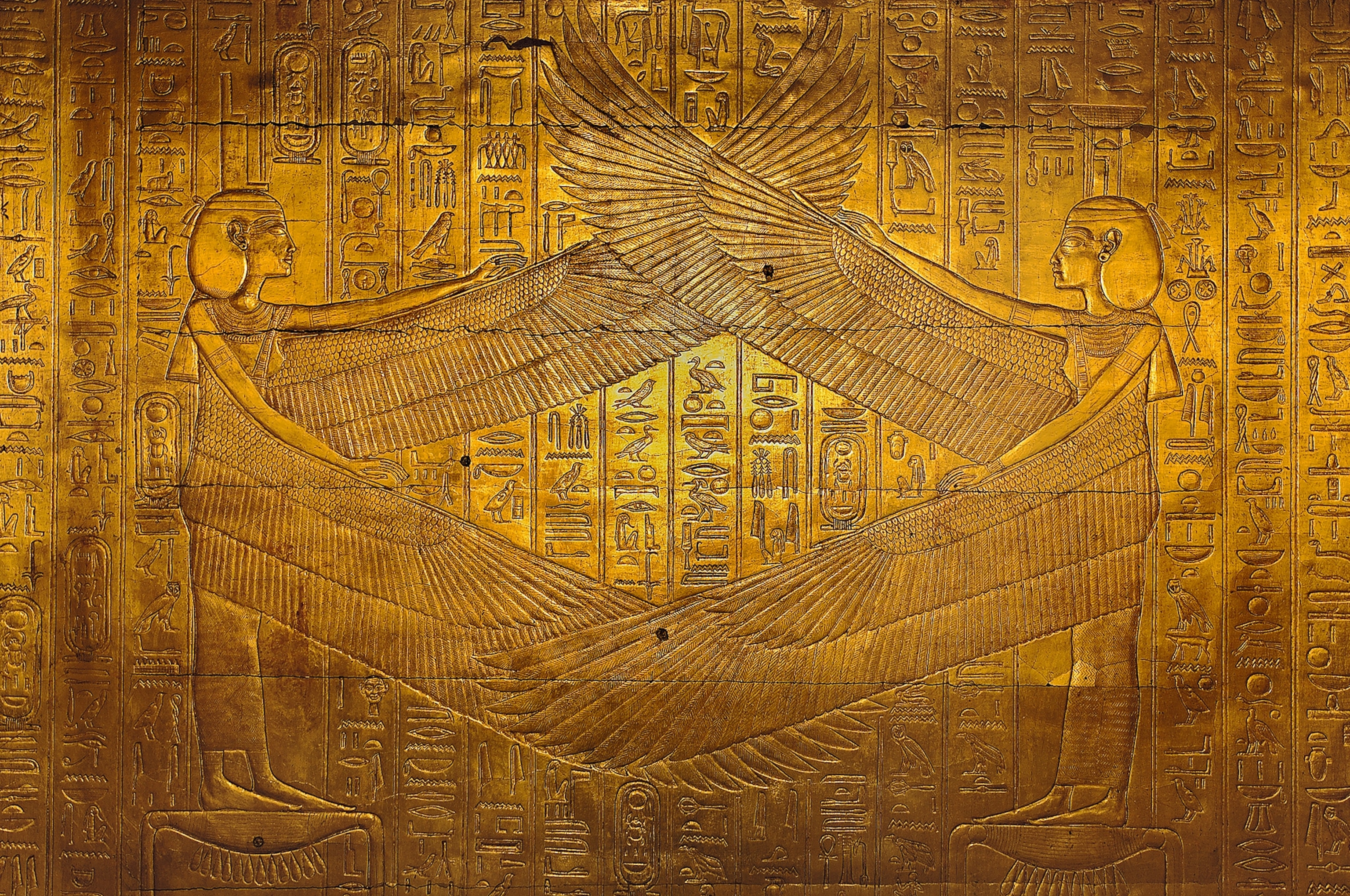 The goddesses Isis (left) and Nephthys (right) are surrounded by sacred texts in the third golden shrine of the tomb of Pharaoh Tutankhamun.