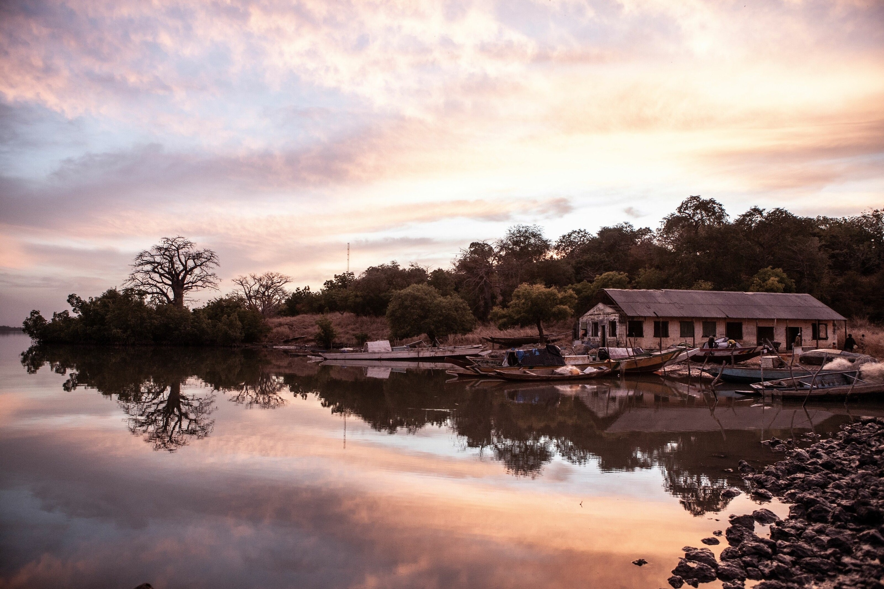 Sunset over Ballingo Tenda, a launch site for local fisherman on a bank of the Gambia River. Tendas also make excellent spots to moor for the night when navigating the river. Travellers can disembark and head into villages to meet the alkalo (village chief), pick up supplies and, if they’re lucky, be asked to join a family for a plate of domada, a peanut stew served with rice that’s one of the country’s national dishes.