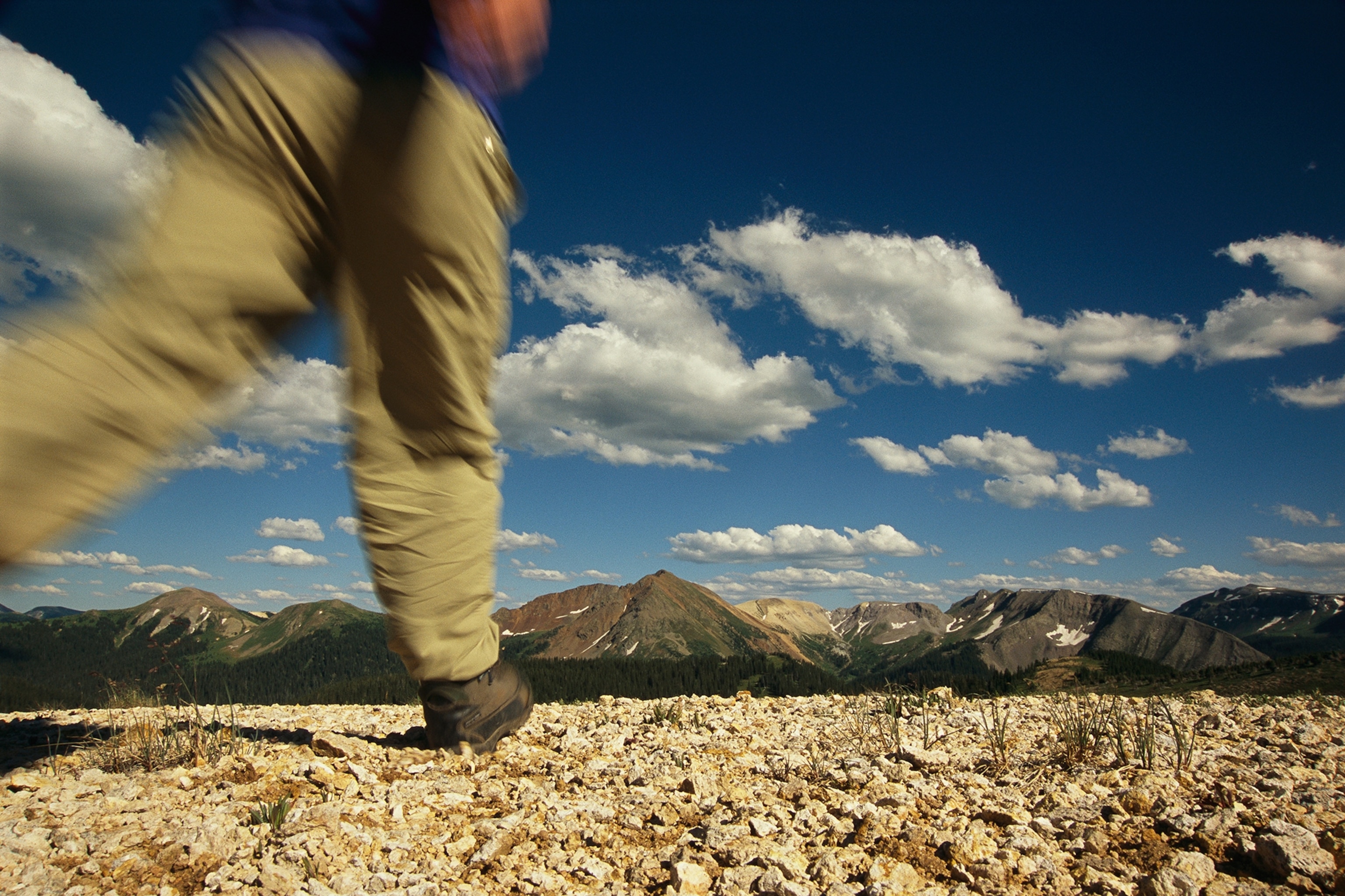 person walking towards mountain