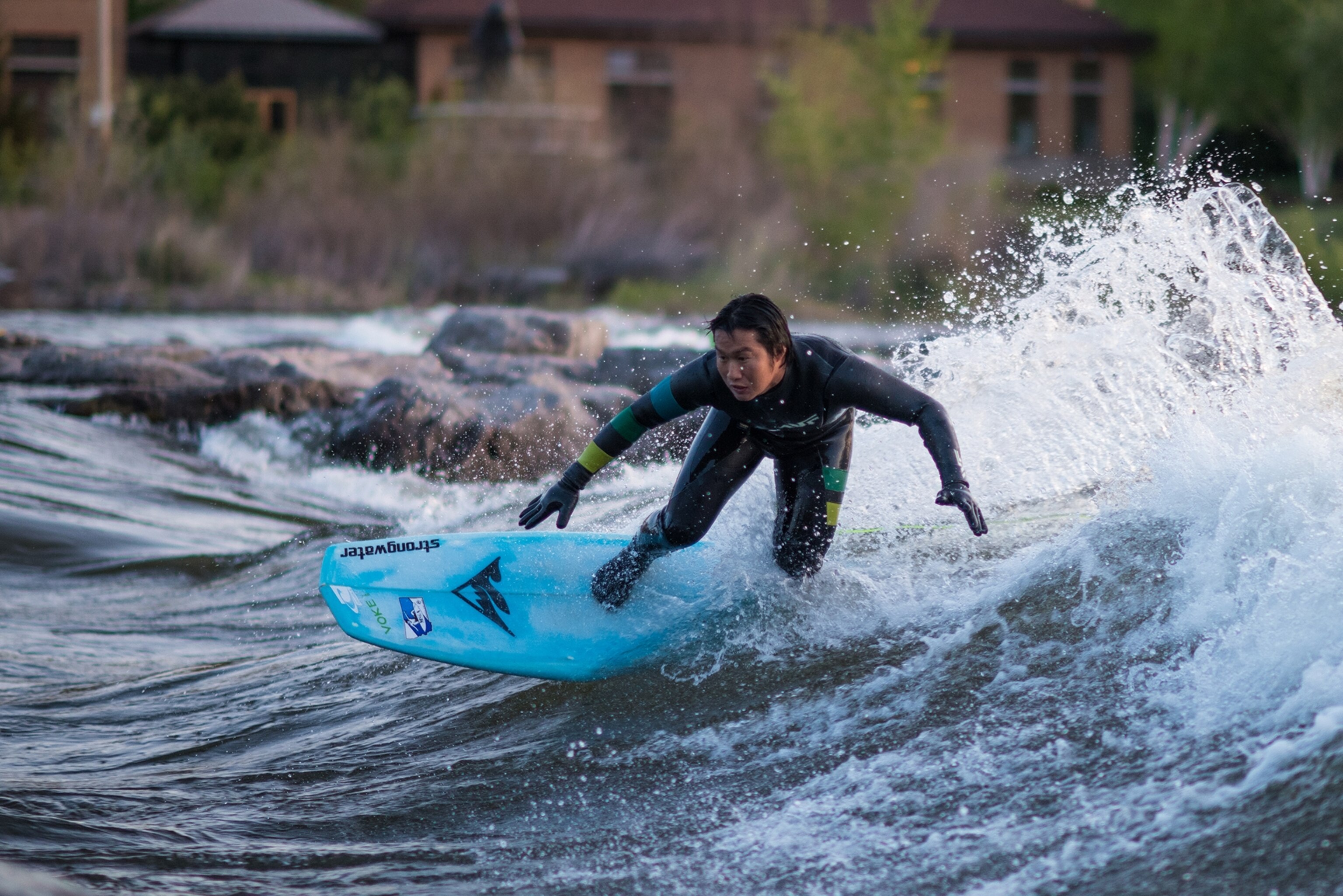 a surfer riding a wave on the Clark Fork River in Missoula, Montana