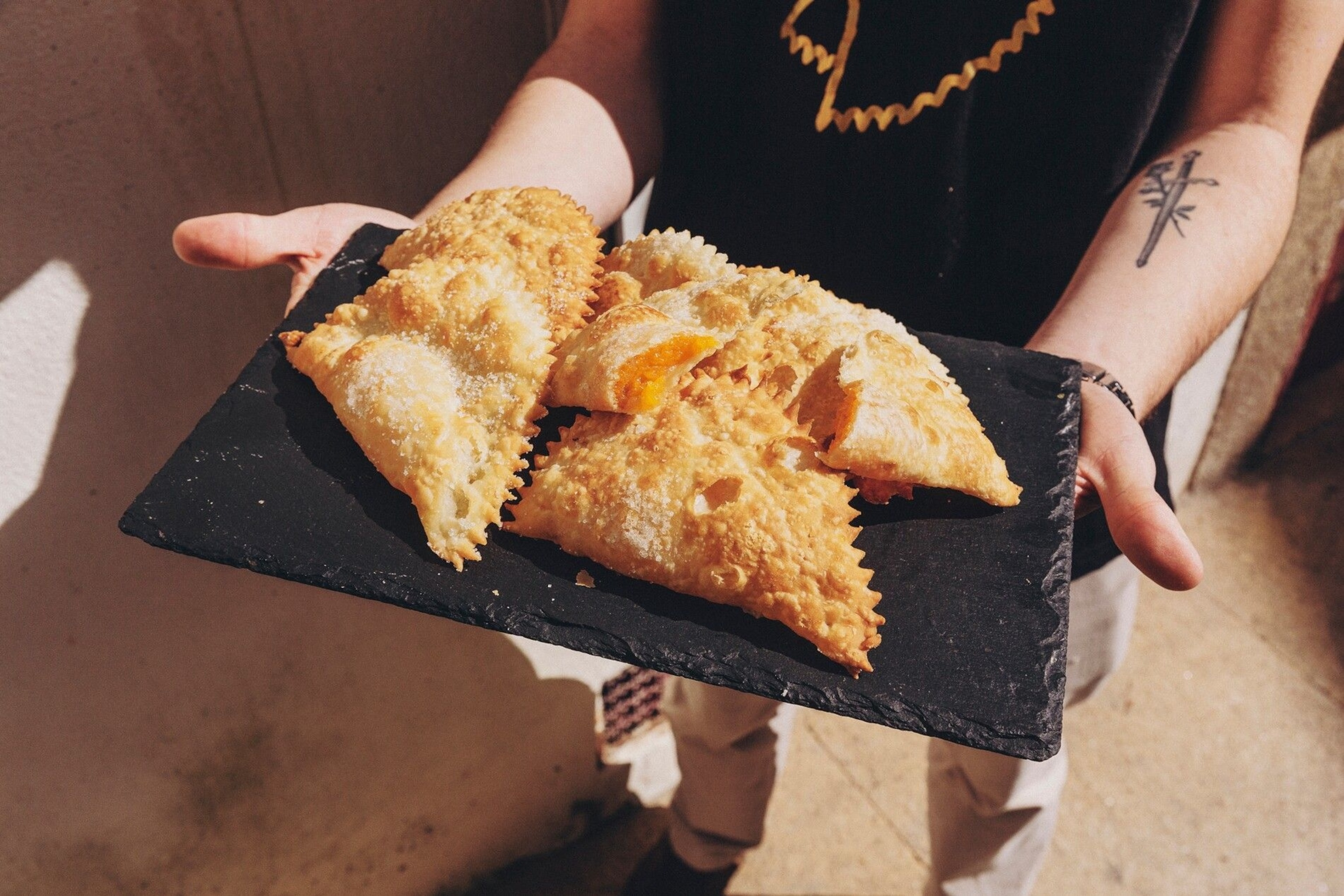 Afonso Cramez of Casa Lapão in Vila Real, holds a plate of crista de galo, a traditional sweet pastry filled with an egg-yolk paste.