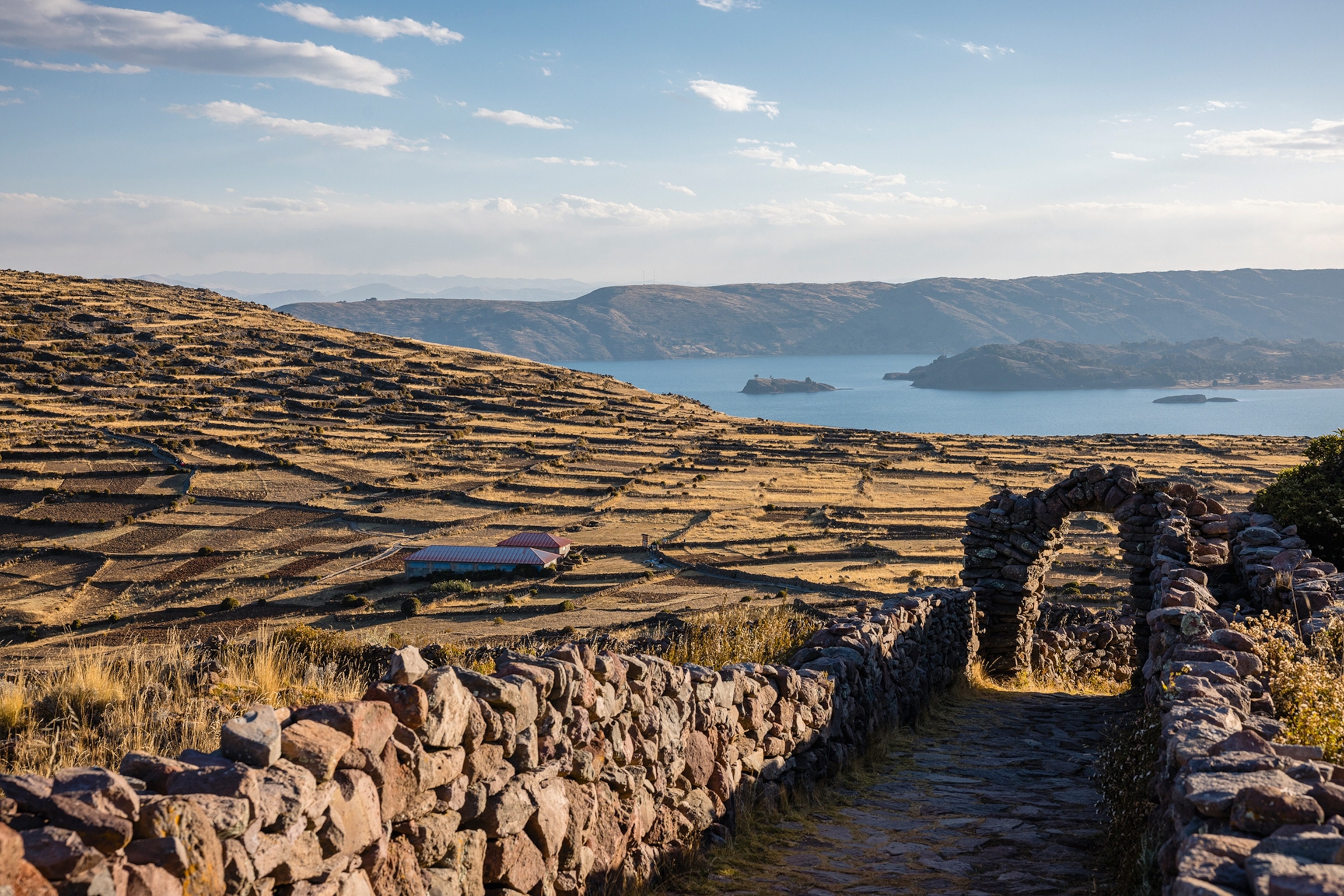 A rocky landscape with stone arches leading to simple villages.