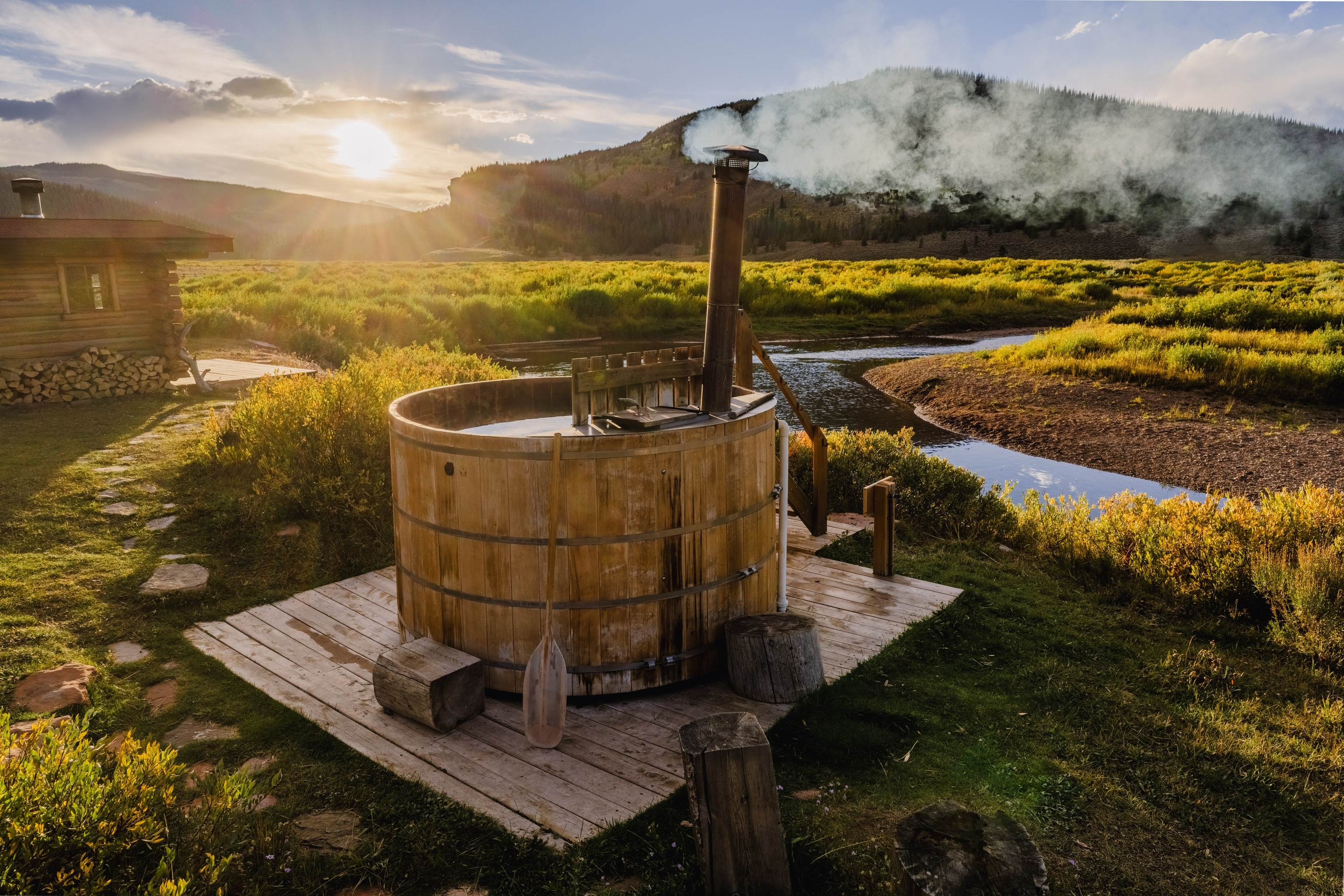 cedar wood-fired hot tub on the creek bank
