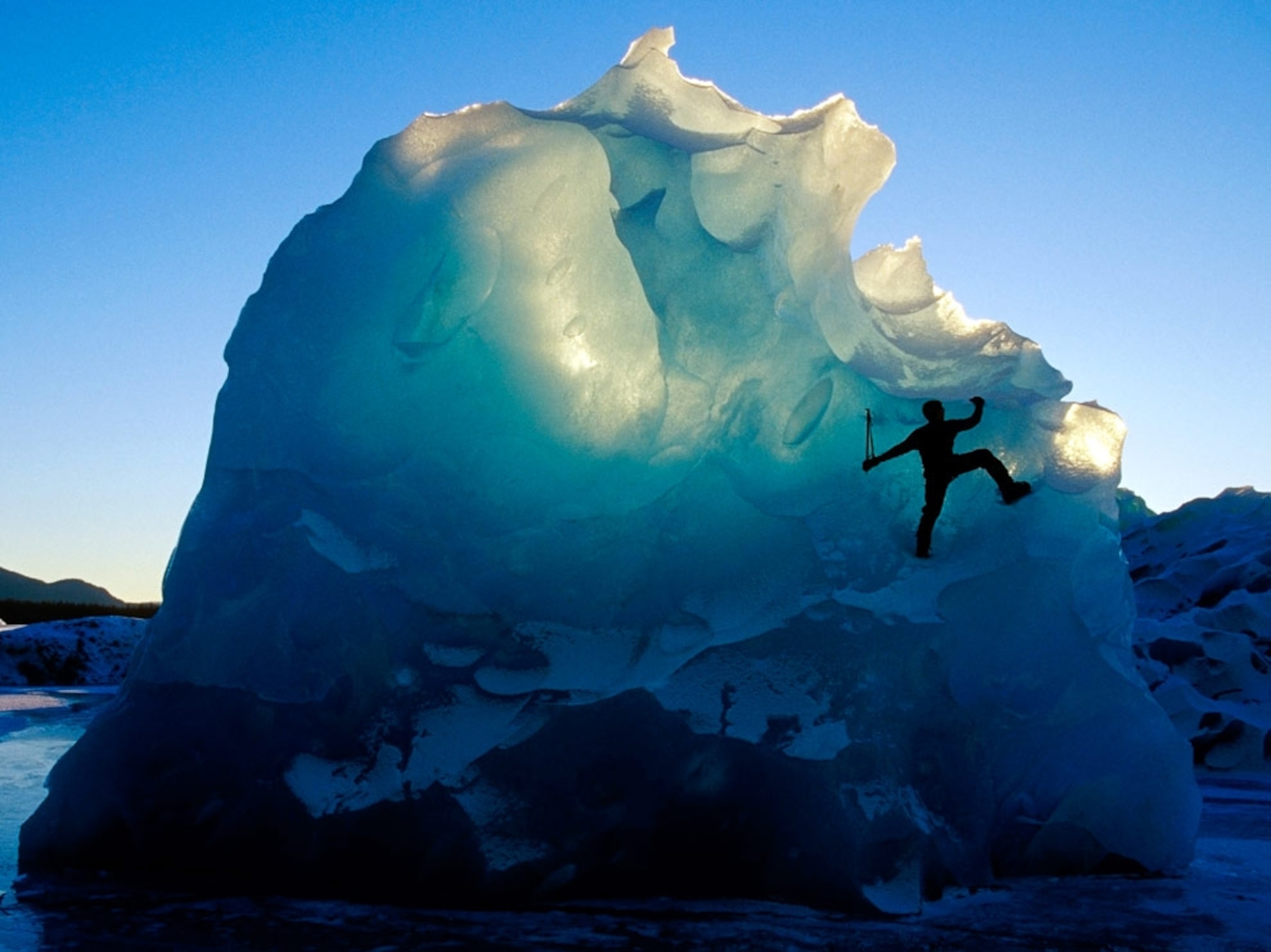 A man climbing an iceberg