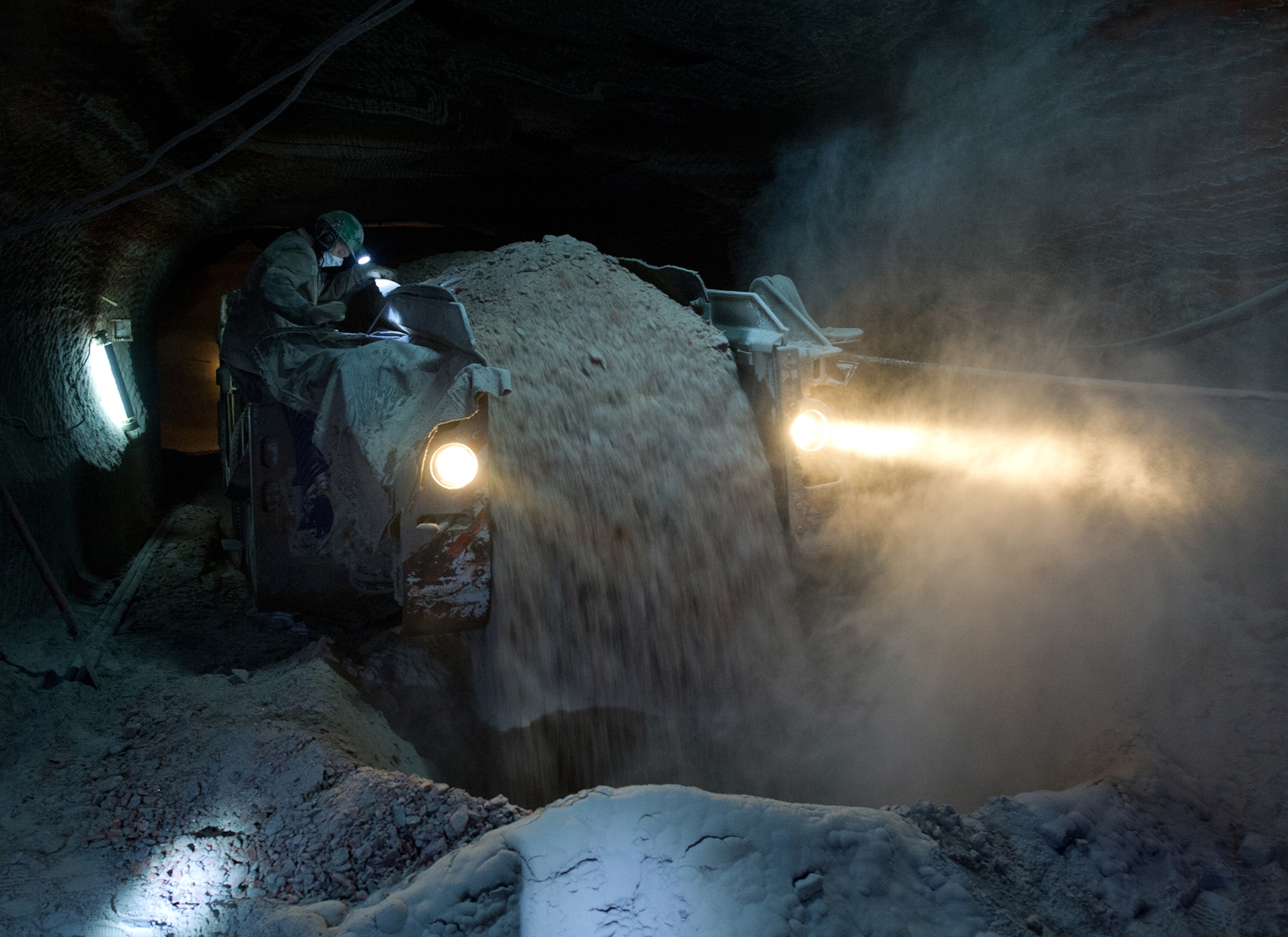 a worker using a machine to sift crushed sylvinite rock
