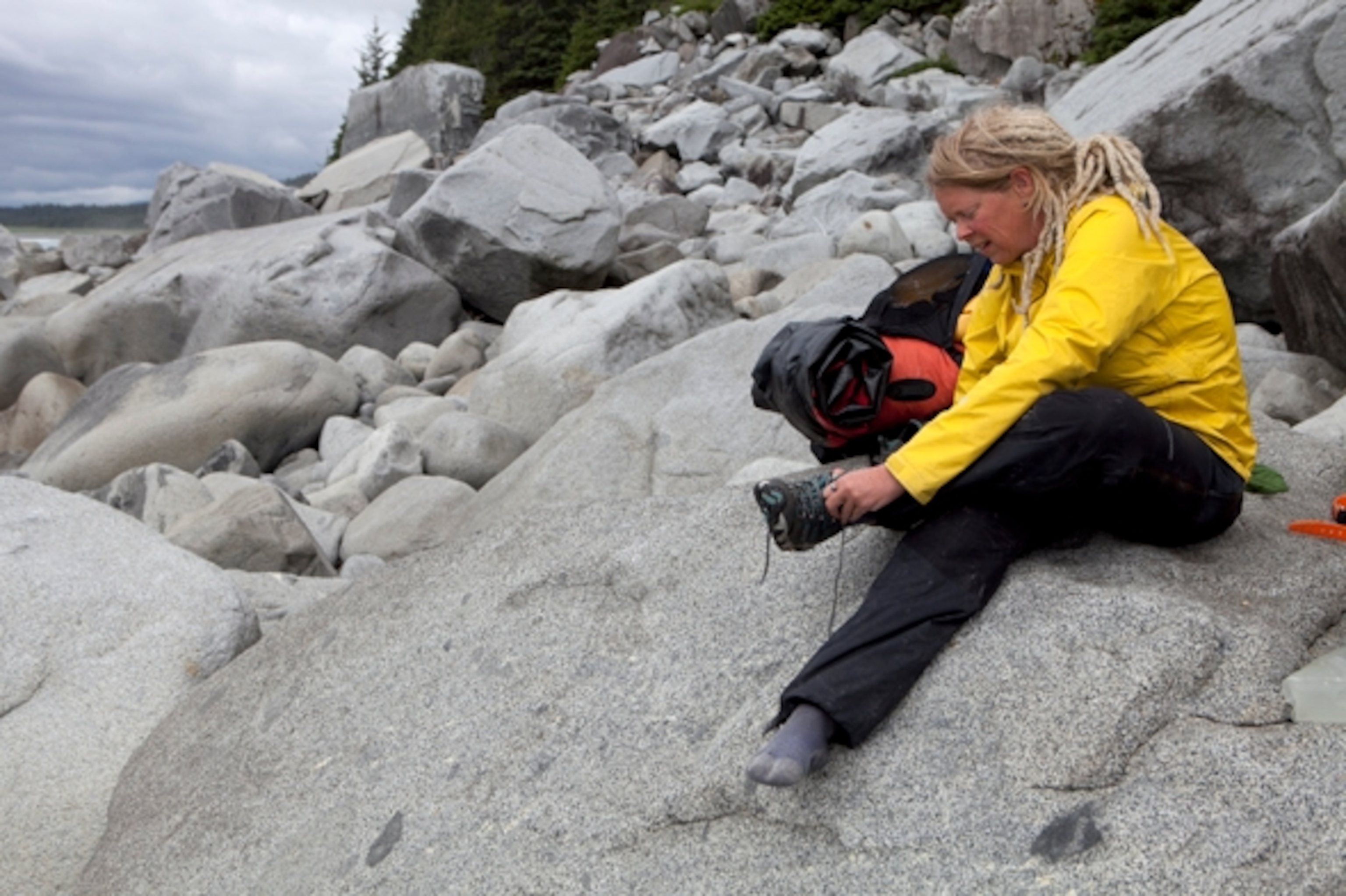 After exiting the forest near Grand Plateau Lake, Iris gets ready to ride south toward Lituya Bay; Photograph by Cameron Lawson