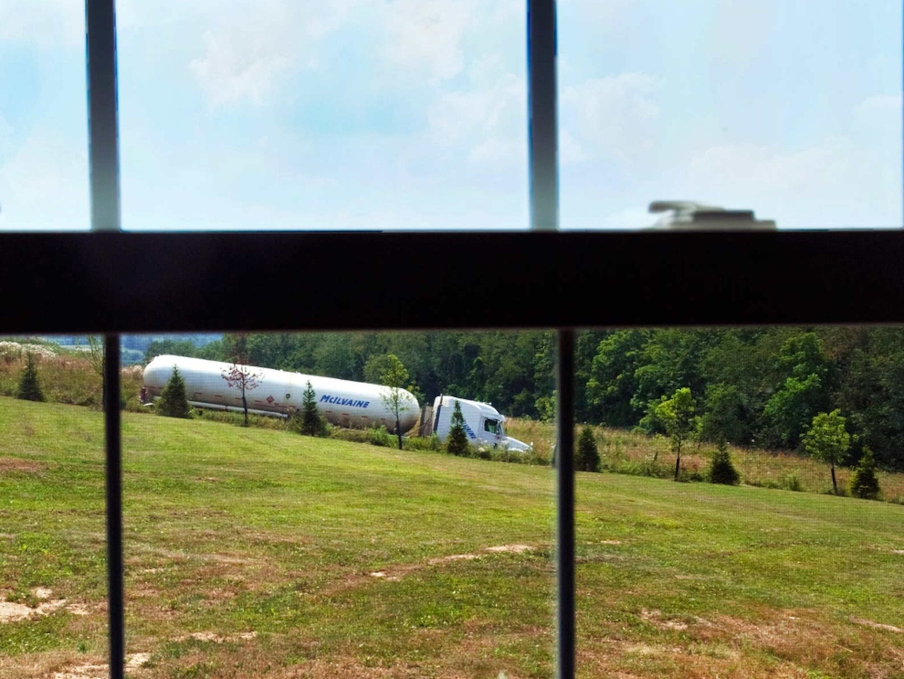 Gas trucks can be seen driving by from the living room window of the Hallowich home.