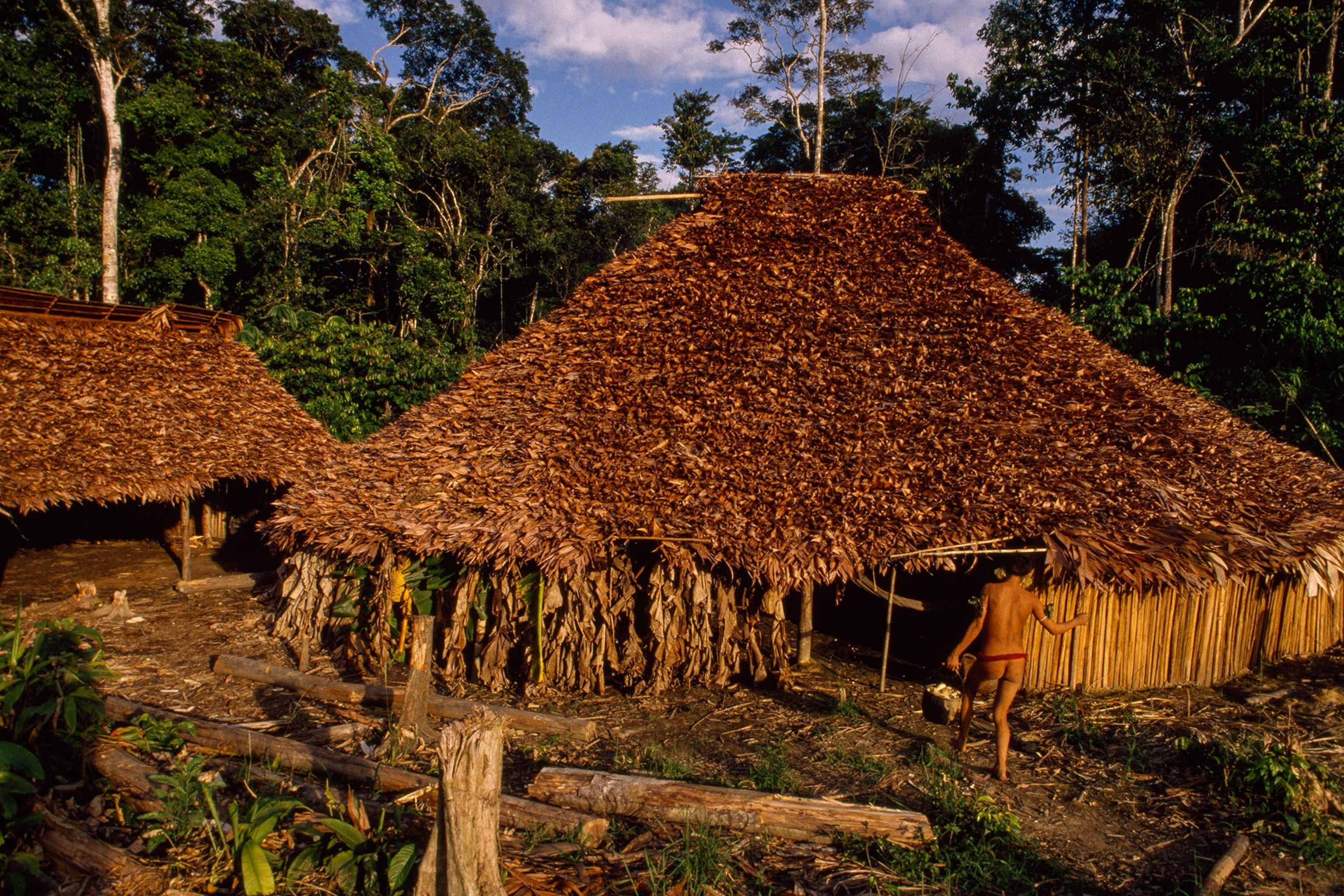tribe members around a hut