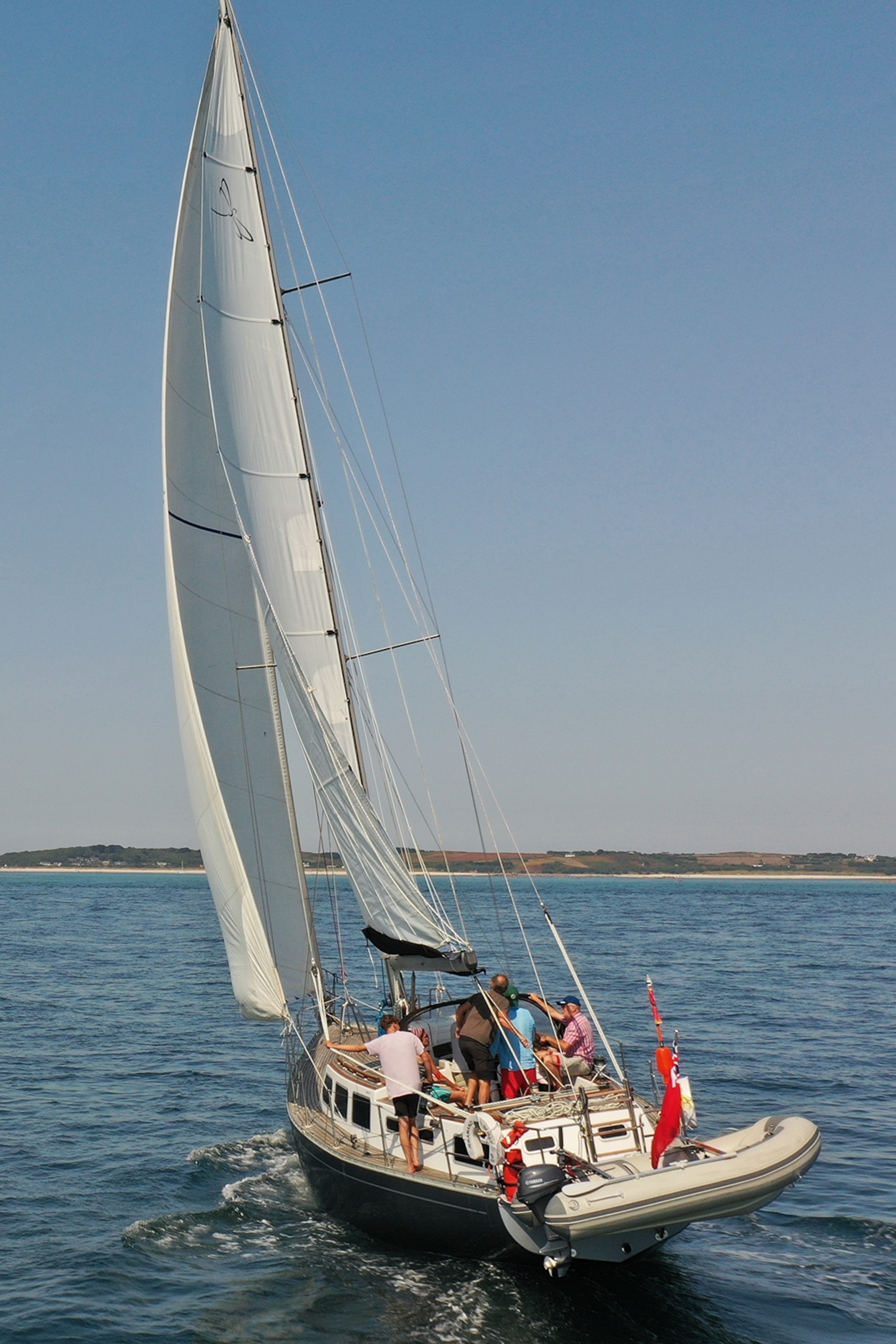 A yacht sails on the sea on a sunny day.