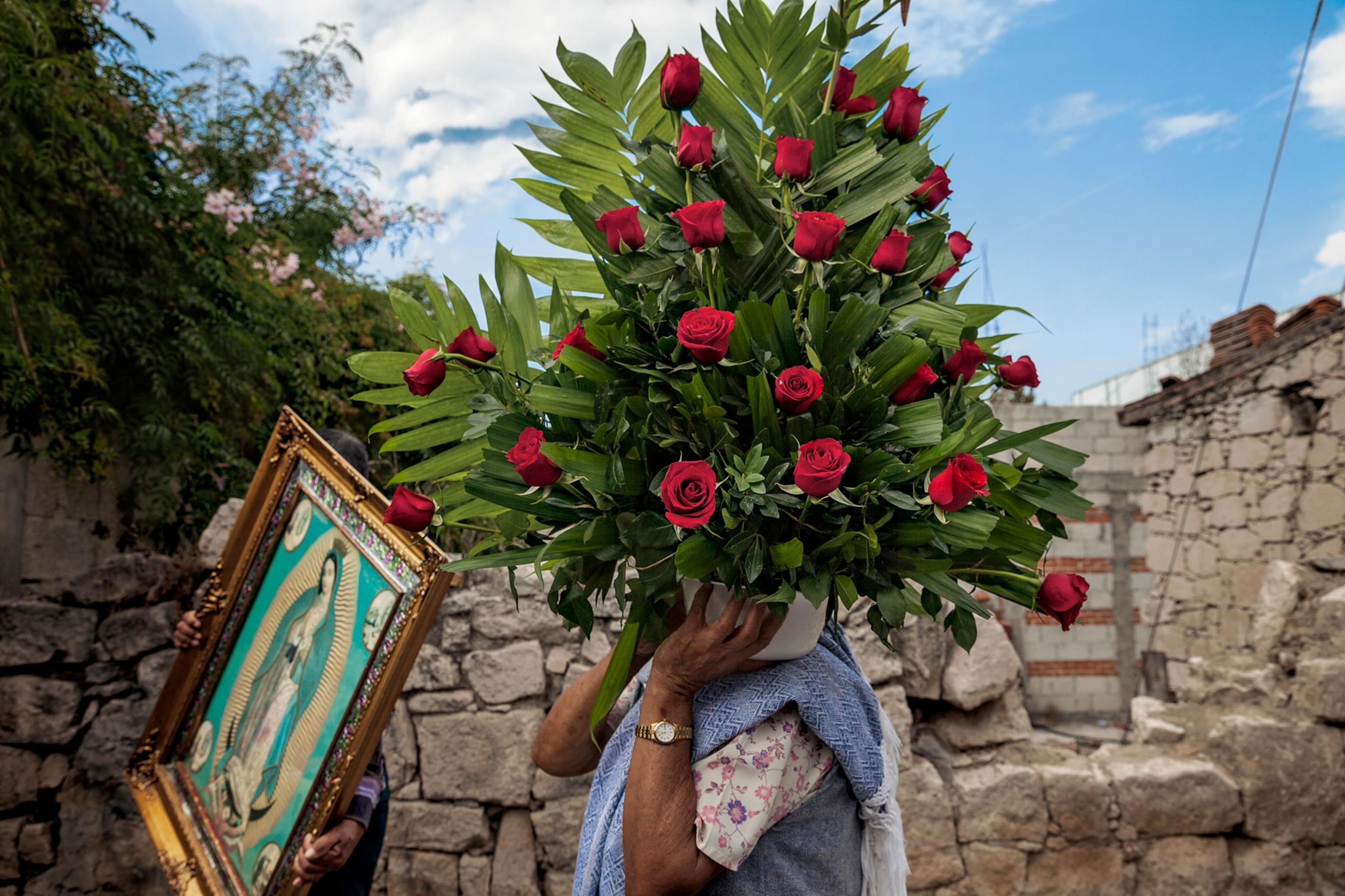 a women holding a large bouquet of roses.