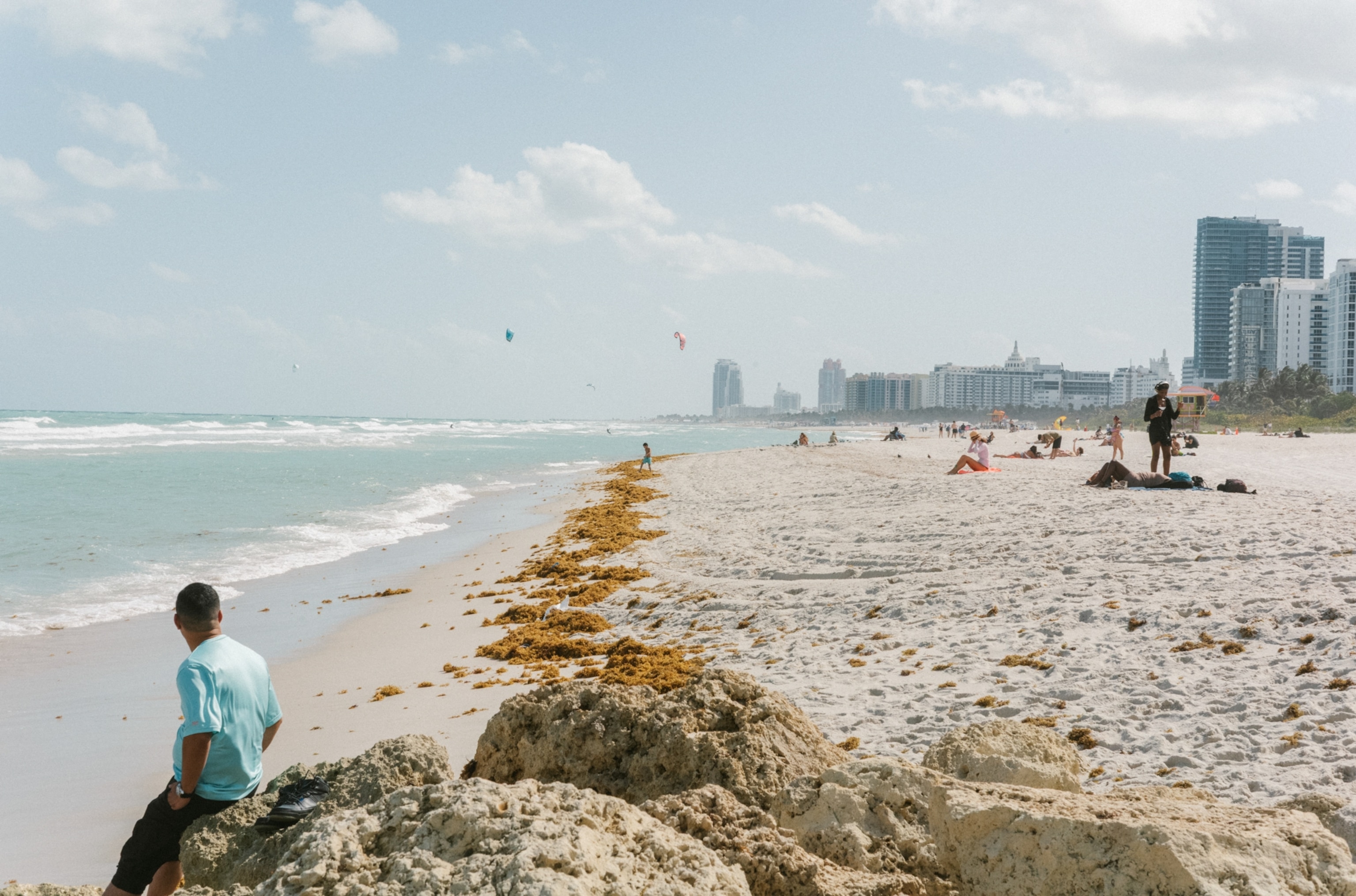A man watches kitesurfers in South Beach.