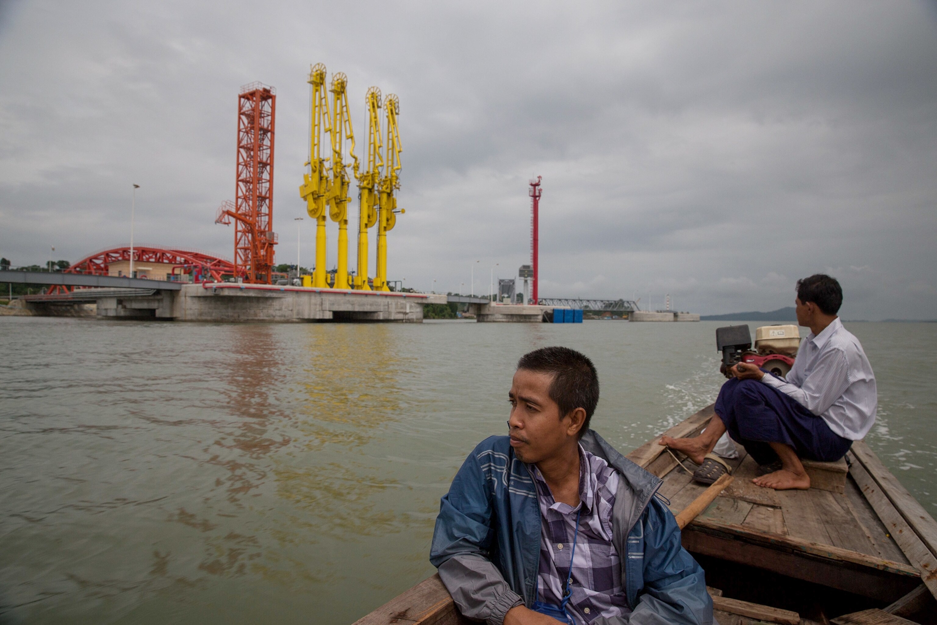 a boatman steering through a mangrove swamp near the start of a 1,500 mile oil pipeline from the Bay of Bengal to China's Yunan province.