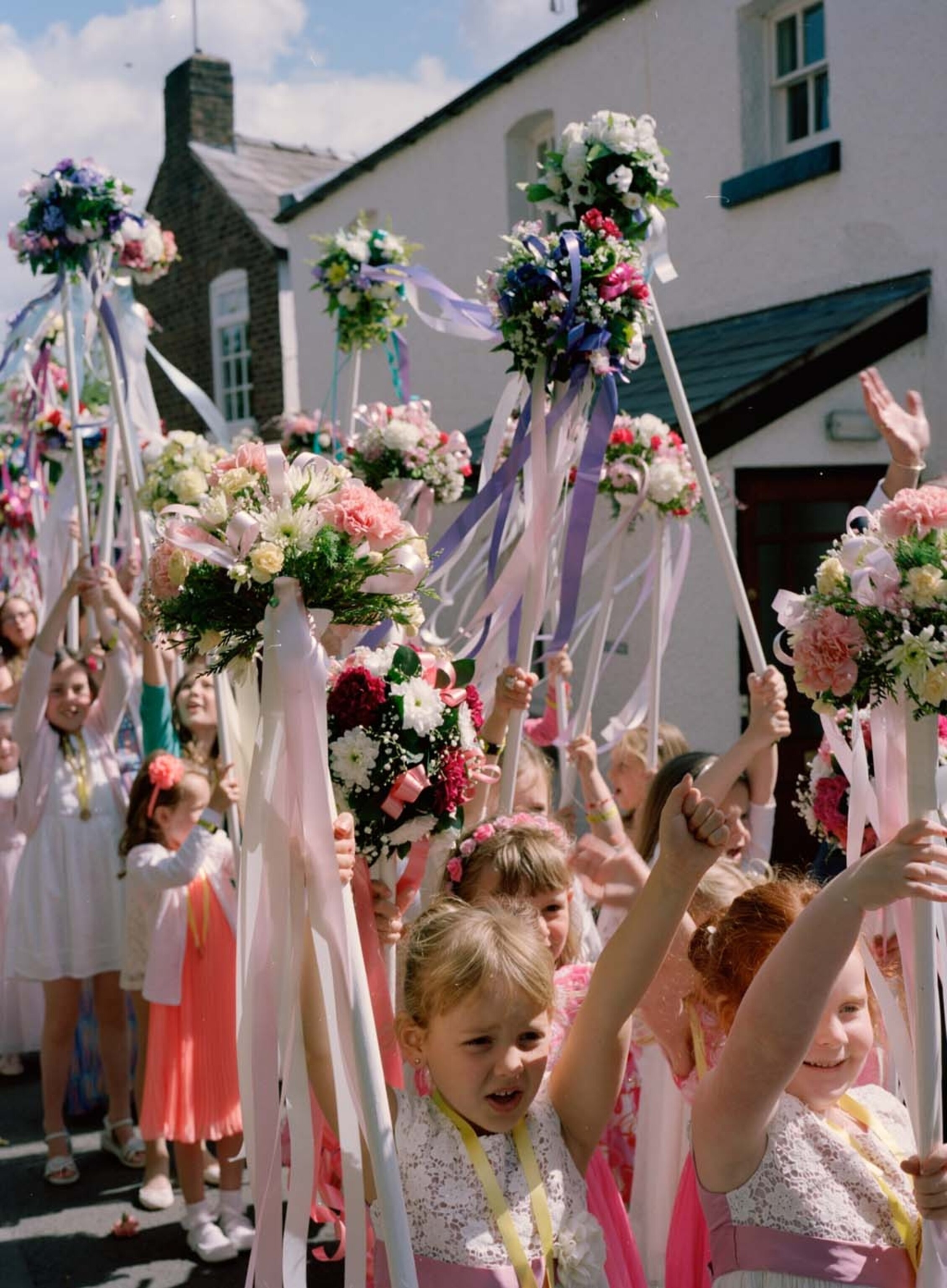 girls holding flowers in the air