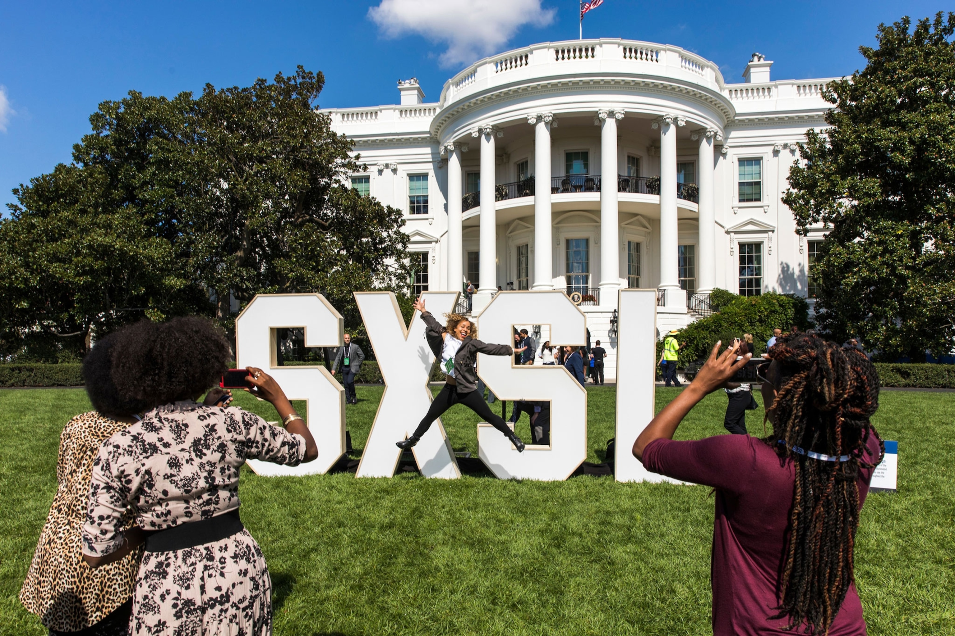 visitors taking photos on the South Lawn of the White House