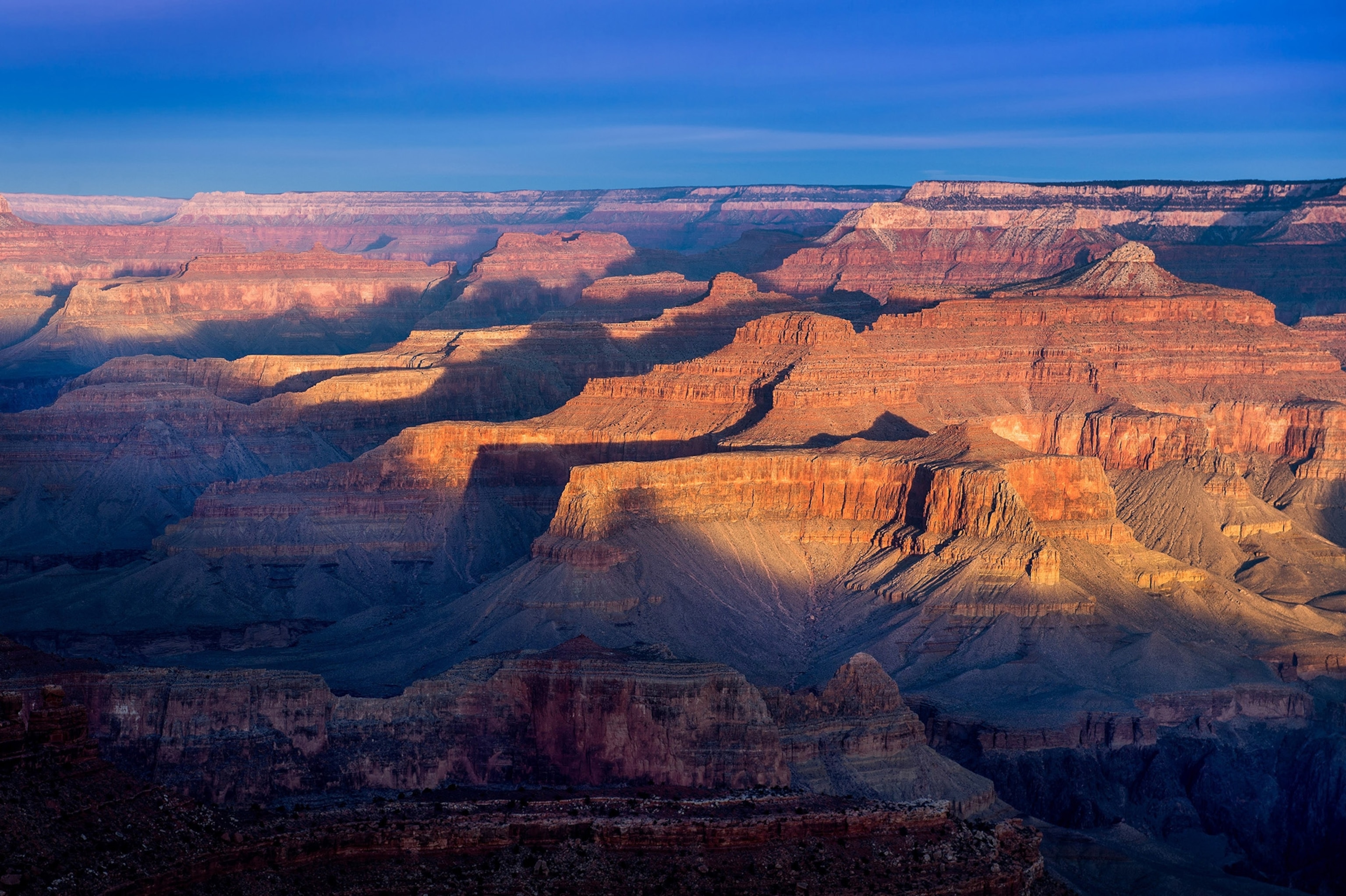 Sun illuminates the rim of the Grand Canyon