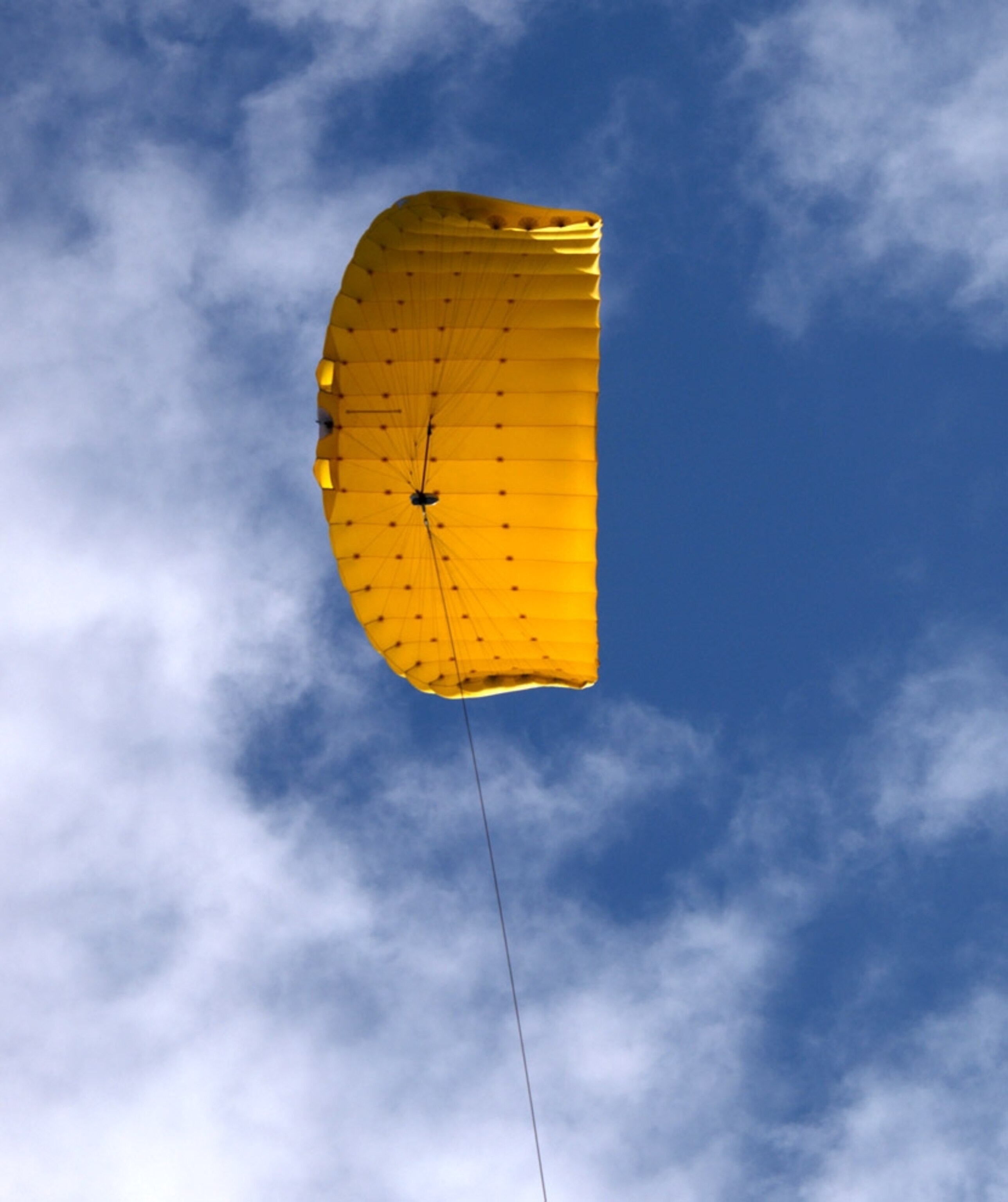 A yellow SkySail deployed