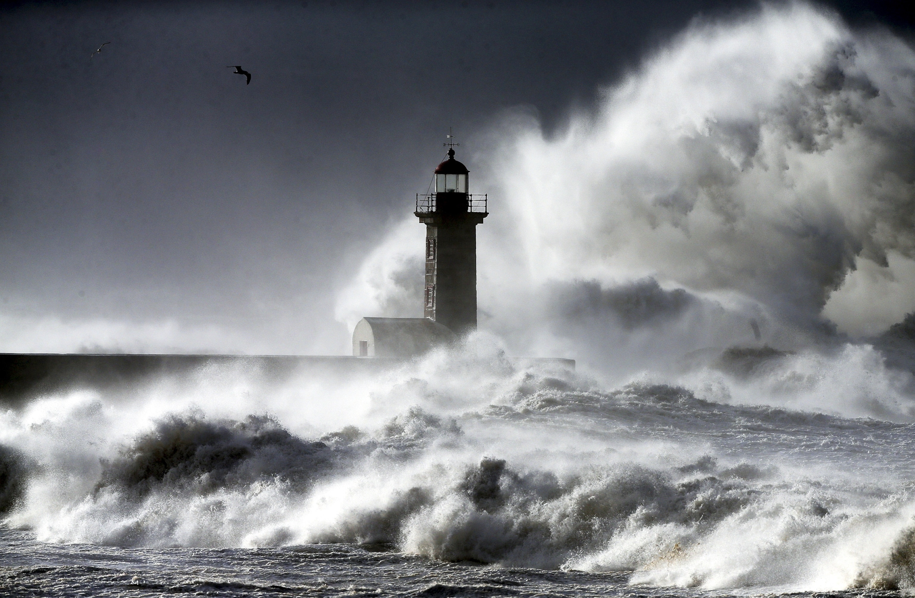 heavy surf slamming into the Cabedelo lighthouse in Portugal on January 19