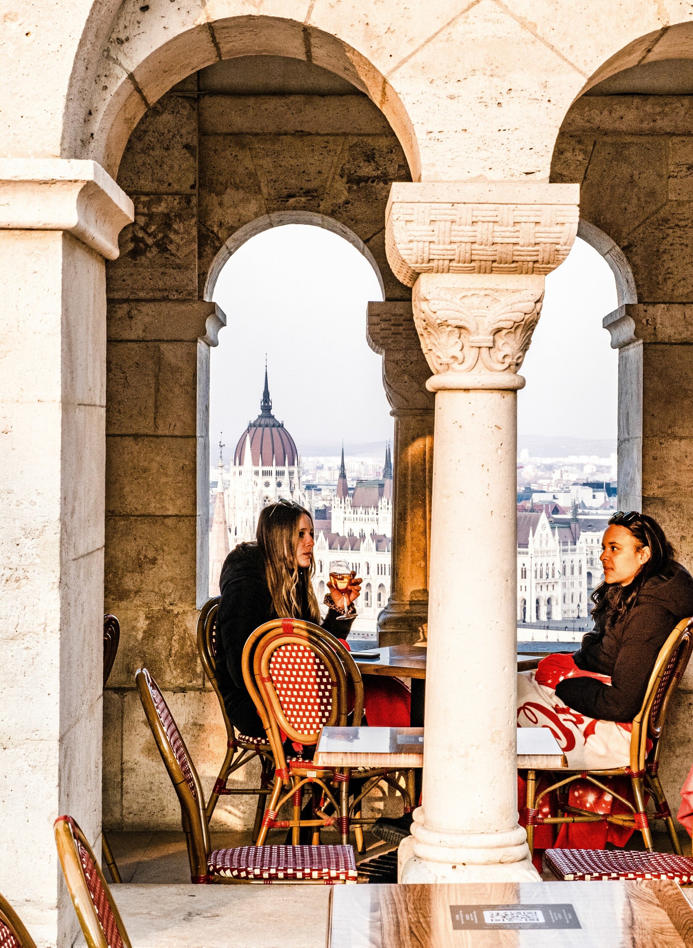 Diners at Panoramia Cafe & Bar on Castle Hill, overlooking the Pest side of the city.