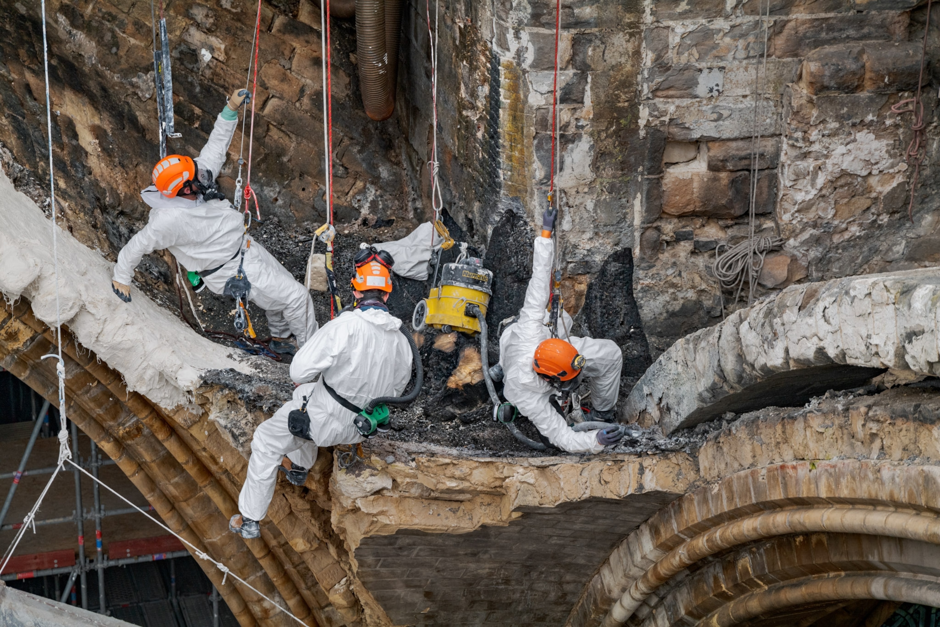 Men using plaster to fix Notre Dame Cathedral
