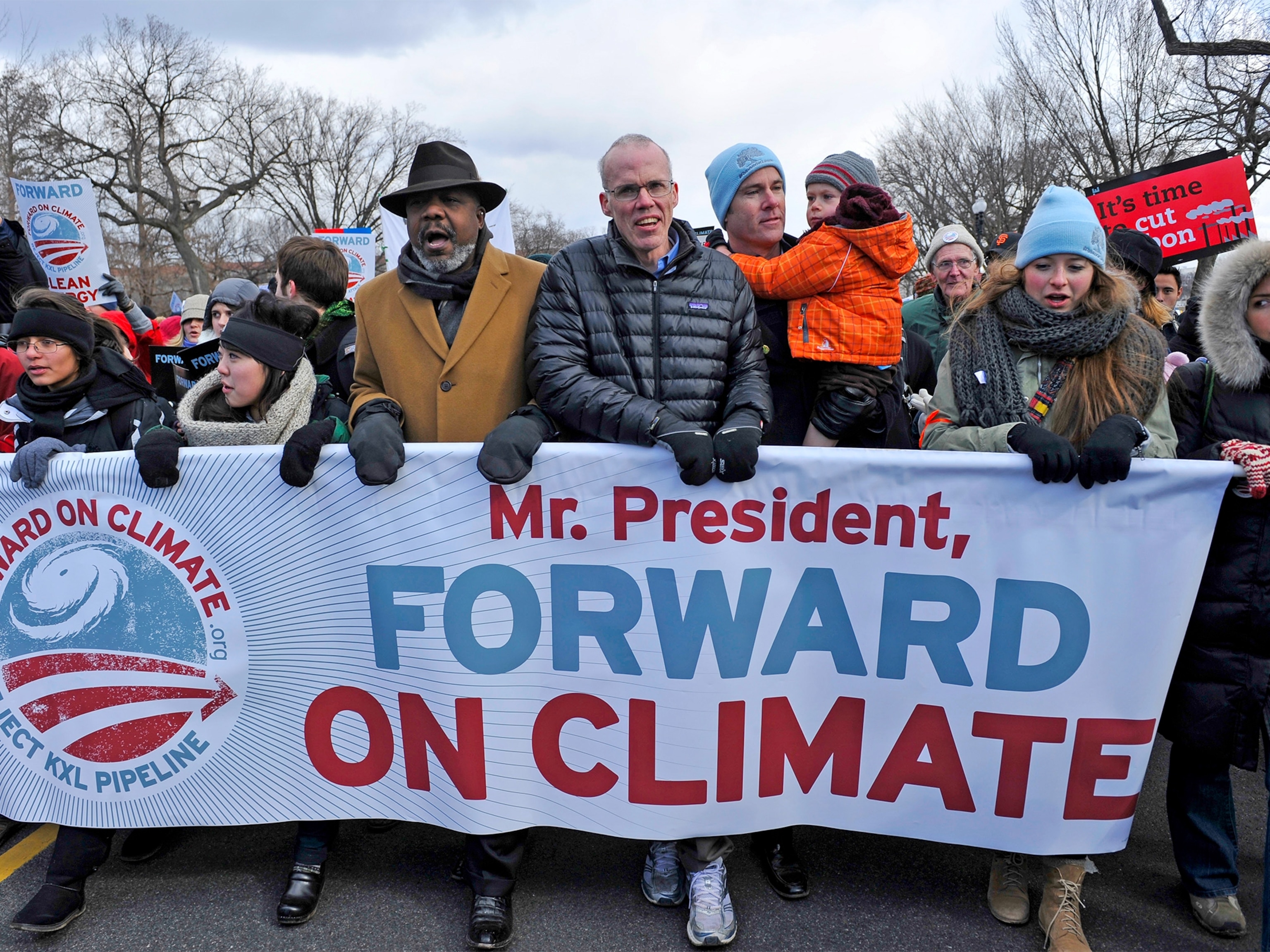 a girl with the earth painted on her face at the People's Climate March in New York